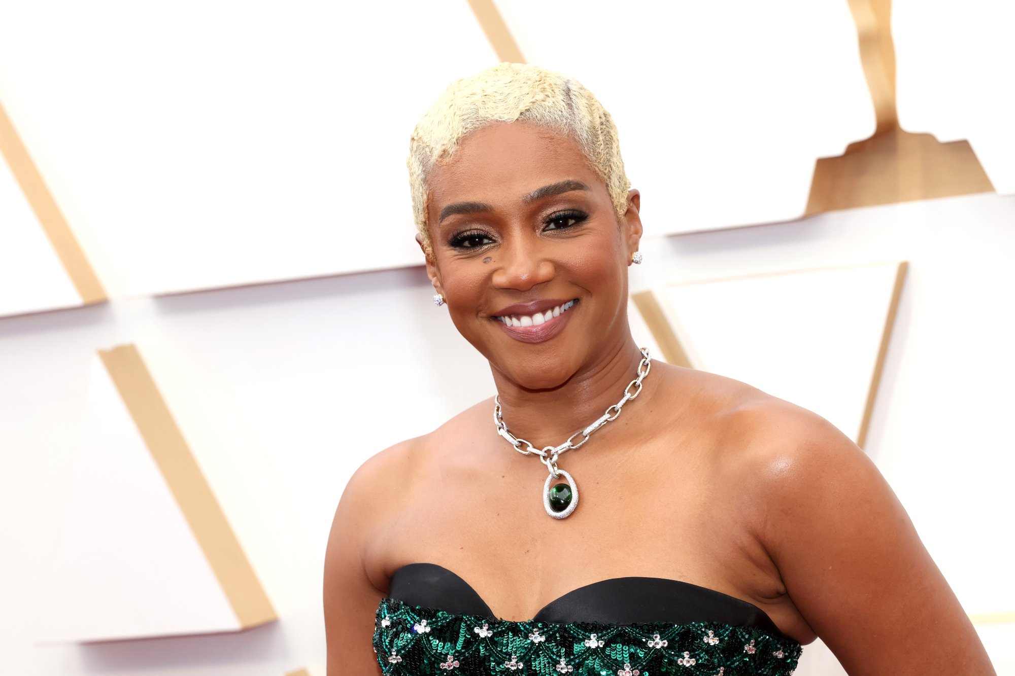 Tiffany Haddish Oscars 2022 smiling in front of Oscars step and repeat