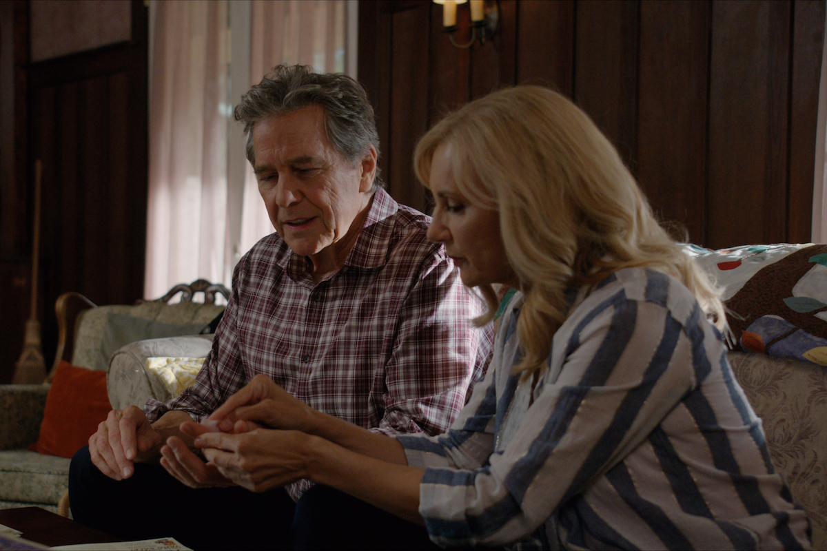 Tim Matheson as Doc Mullins and Gwynth Walsh as Jo Ellen sitting on the couch in 'Virgin River'