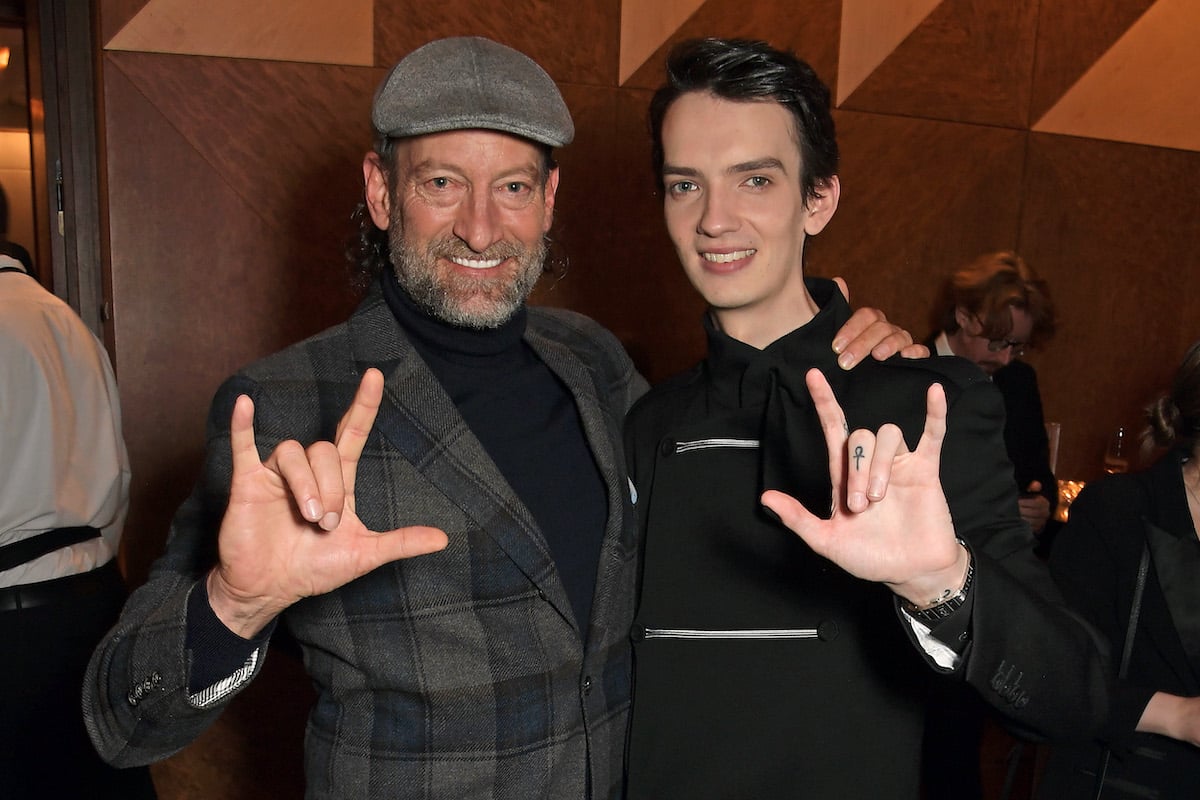 2022 Best Supporting Actor nominees Troy Kotsur and Kodi Smit-McPhee hold up their hands with the American Sign Language sign for "I love you.”