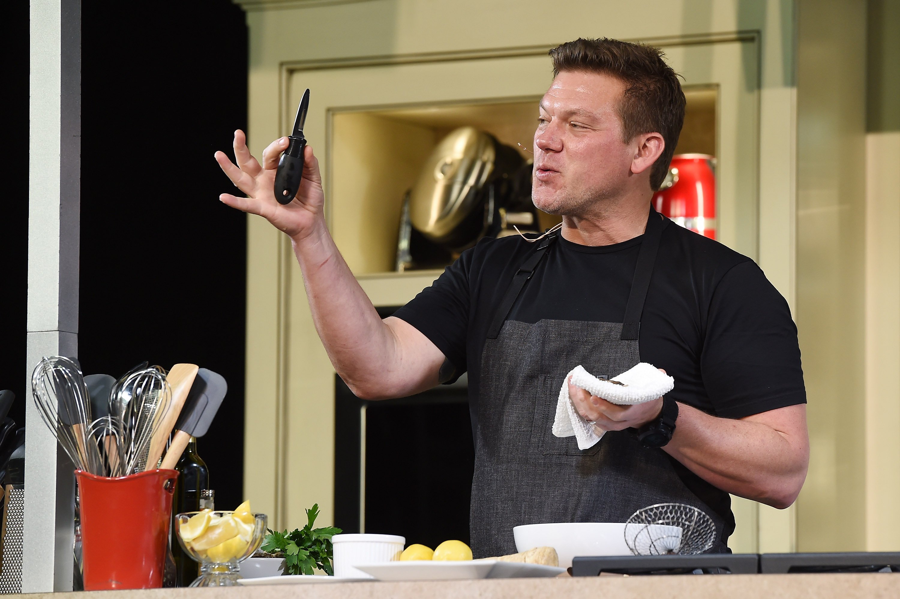 Food Network personality Tyler Florence wears a black tee in this photograph.
