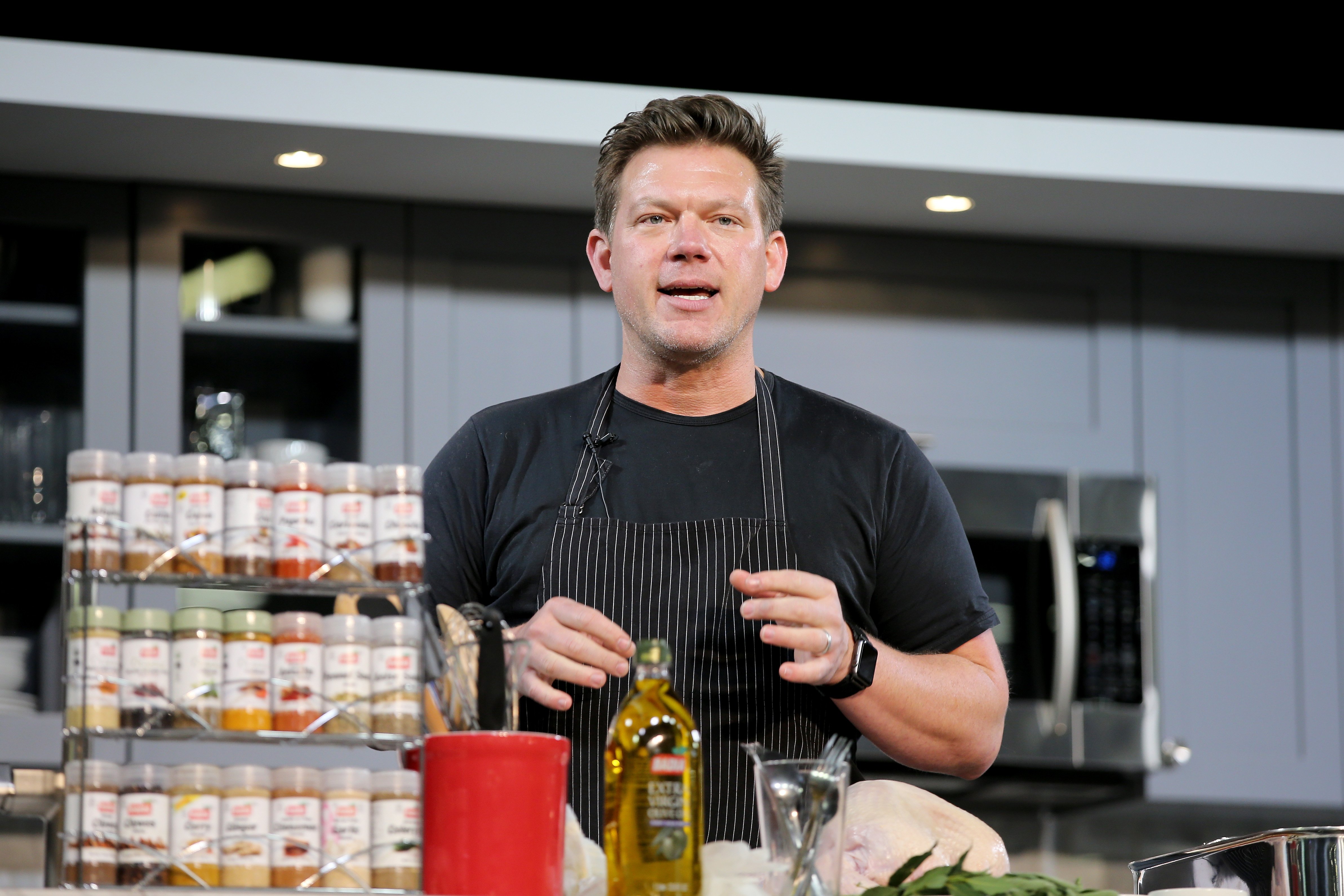 Food Network chef Tyler Florence wears a short-sleeved black tee-shirt in this photograph.