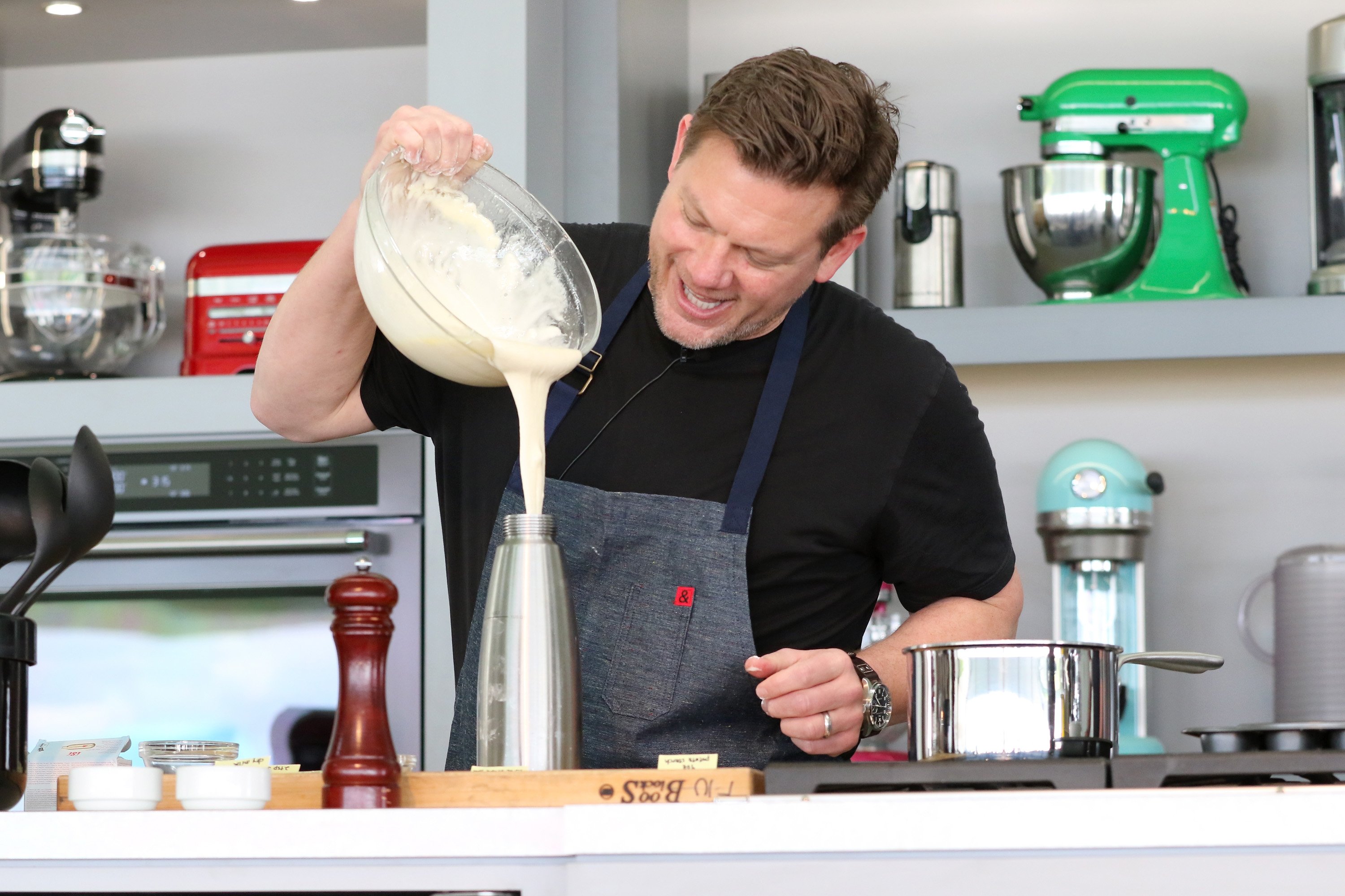 Food Network personality Tyler Florence prepares a dish in this photograph.