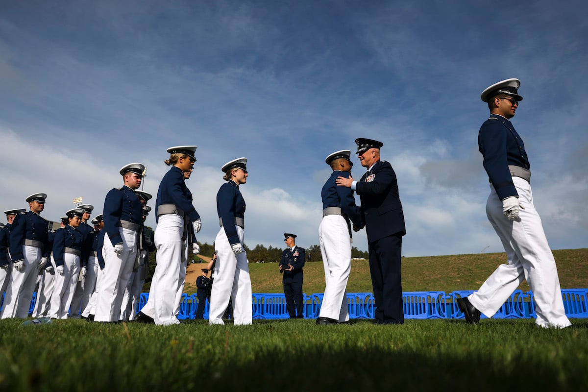 U.S. Air Force Academy graduates are greeted by U.S. Space Force Chief of Space Operations Gen. John W. Raymond, who shakes their hands