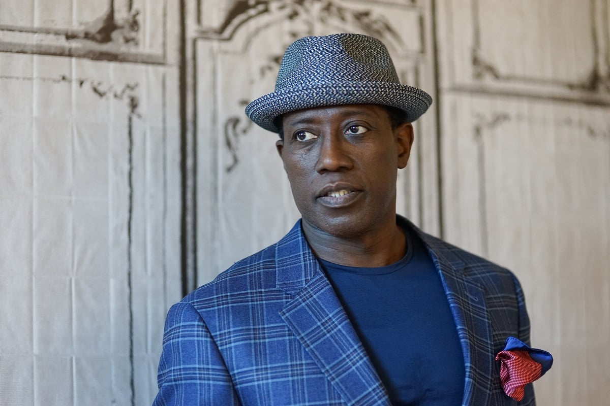 Wesley Snipes posing in a blue suit.