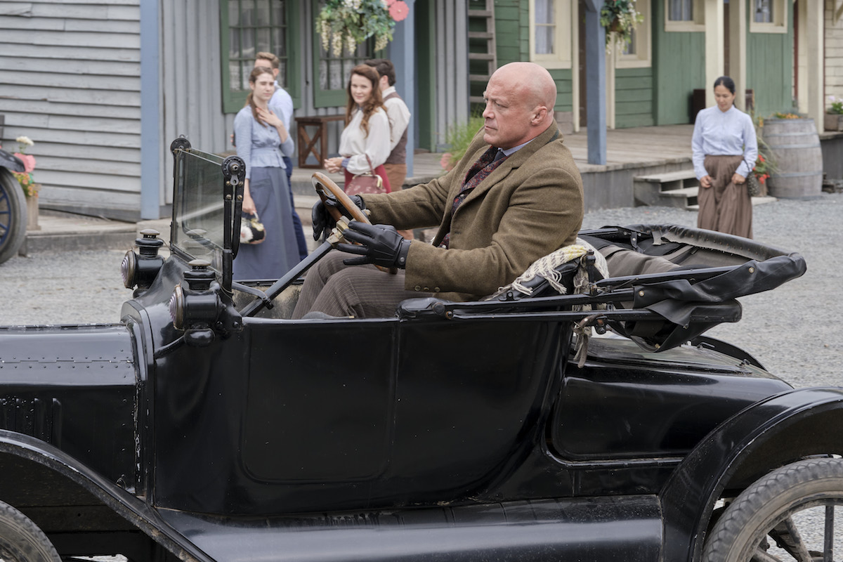 Spurlock driving a car through Hope Valley in 'When Calls the Heart' Season 9