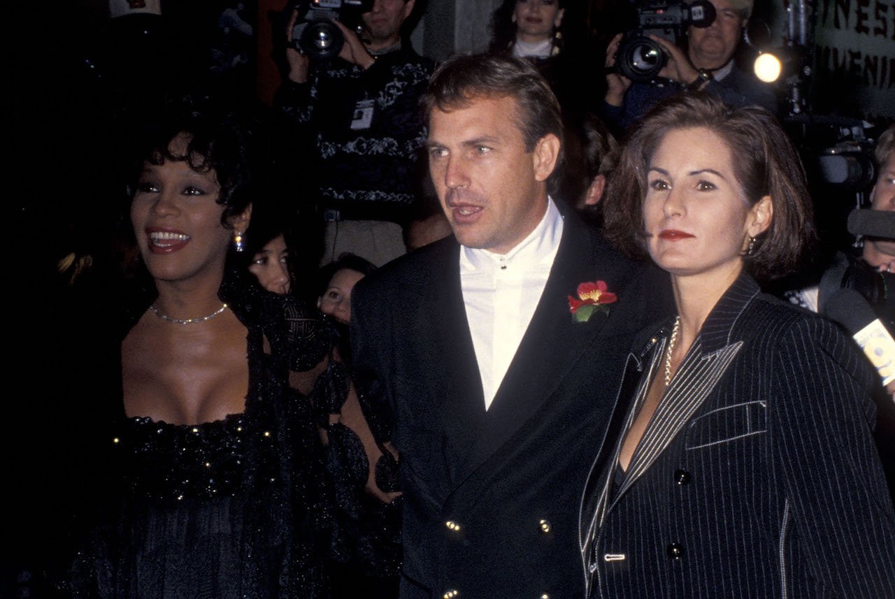 Whitney Houston poses with Kevin Costner and his wife on the red carpet
