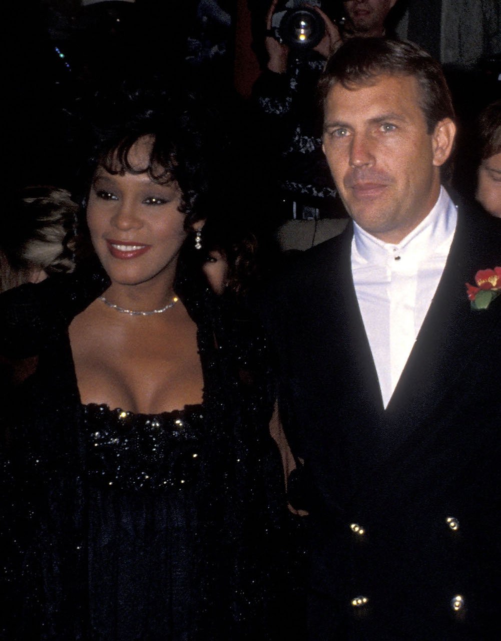 Whitney Houston and Kevin Costner pose for a photo