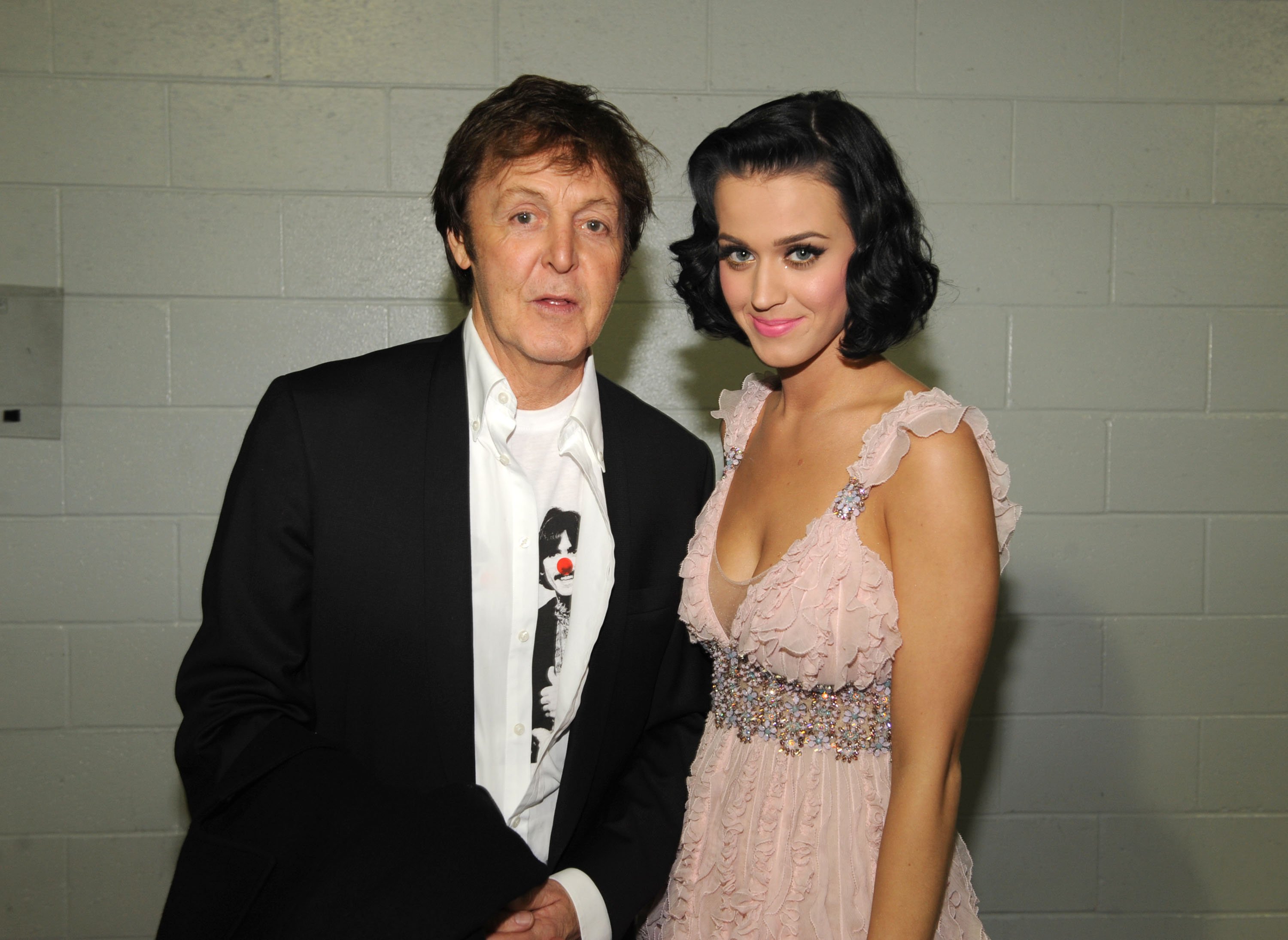 The Beatles' Paul McCartney and Katy Perry standing in front of a white wall