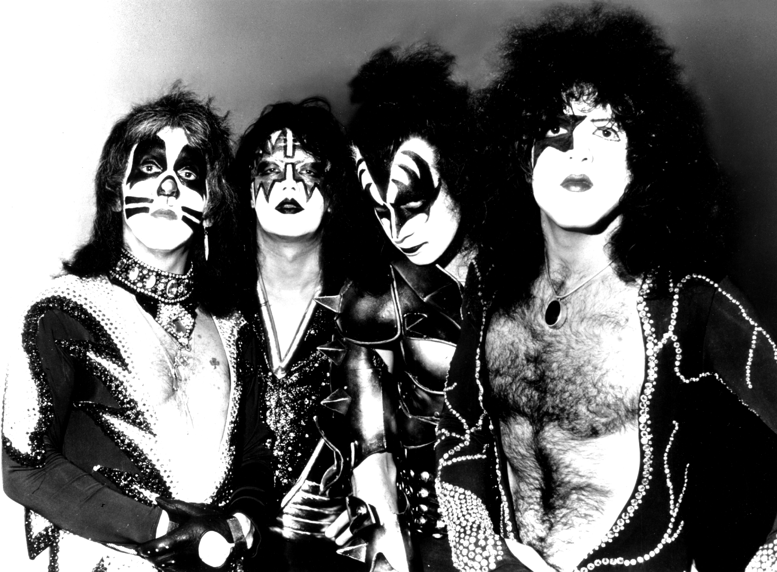 Peter Criss, Ace Frehley, Gene Simmons, and Paul Stanley of Kiss in black-and-white