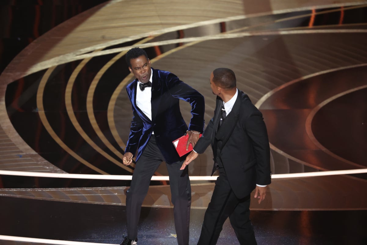 Chris Rock, left, after being slapped by Academy Award-winning actor Will Smith on the Oscars 2022 show stage.