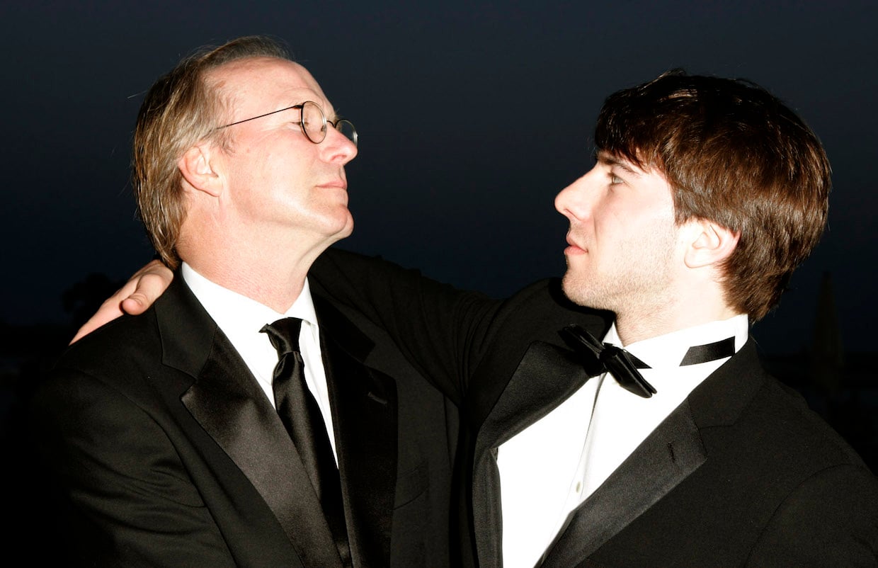 William Hurt looking at his son, Alex, at the Cannes Film Festival. They're both dressed in tuxedos.