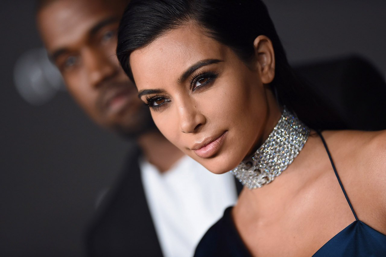 Ye and Kim Kardashian pose for a photo on the red carpet