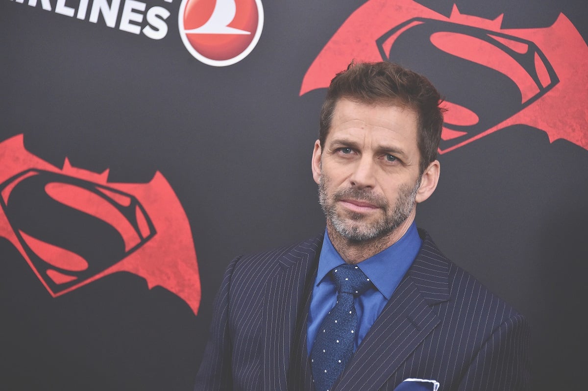 Zack Snyder posing while wearing a blue suit.