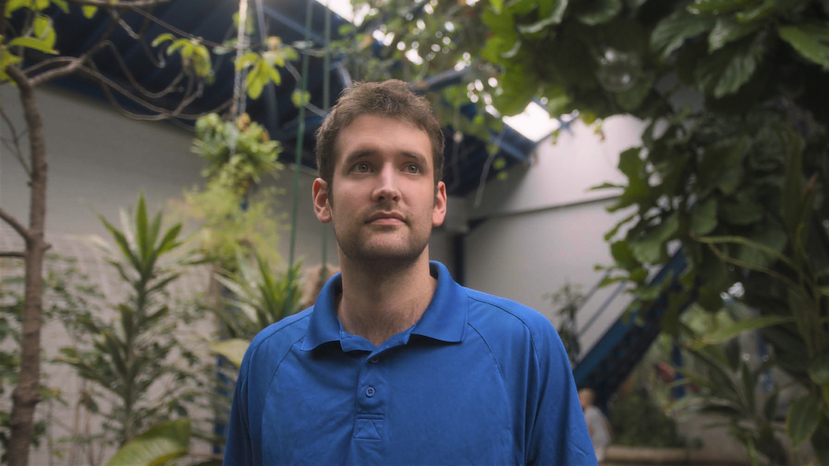 John Cambridge, wearing a blue polo, in 'Bug Out'