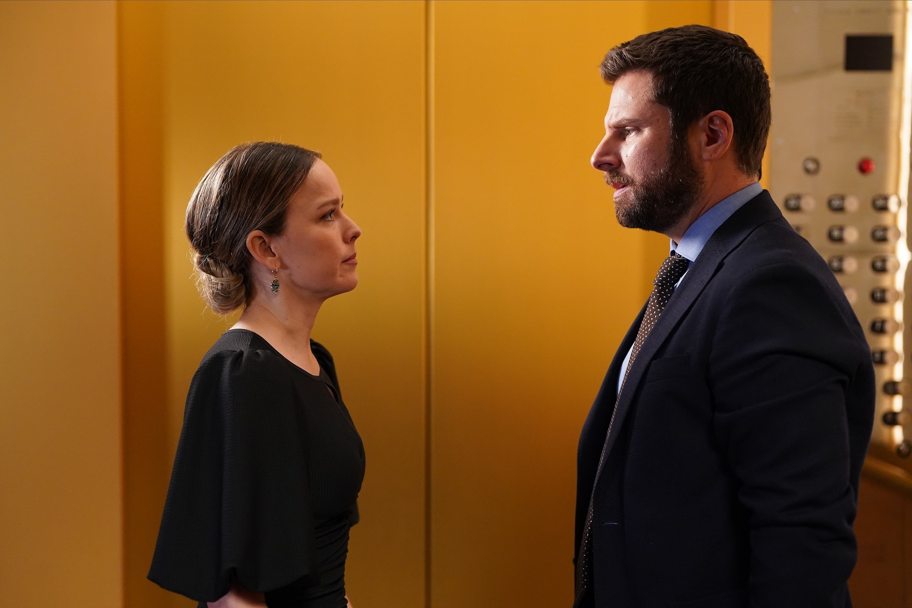 Cast of 'A Million Little Things' Allison Miller and James Roday Rodriguez stare at each other in an an elevator as Maggie and Gary