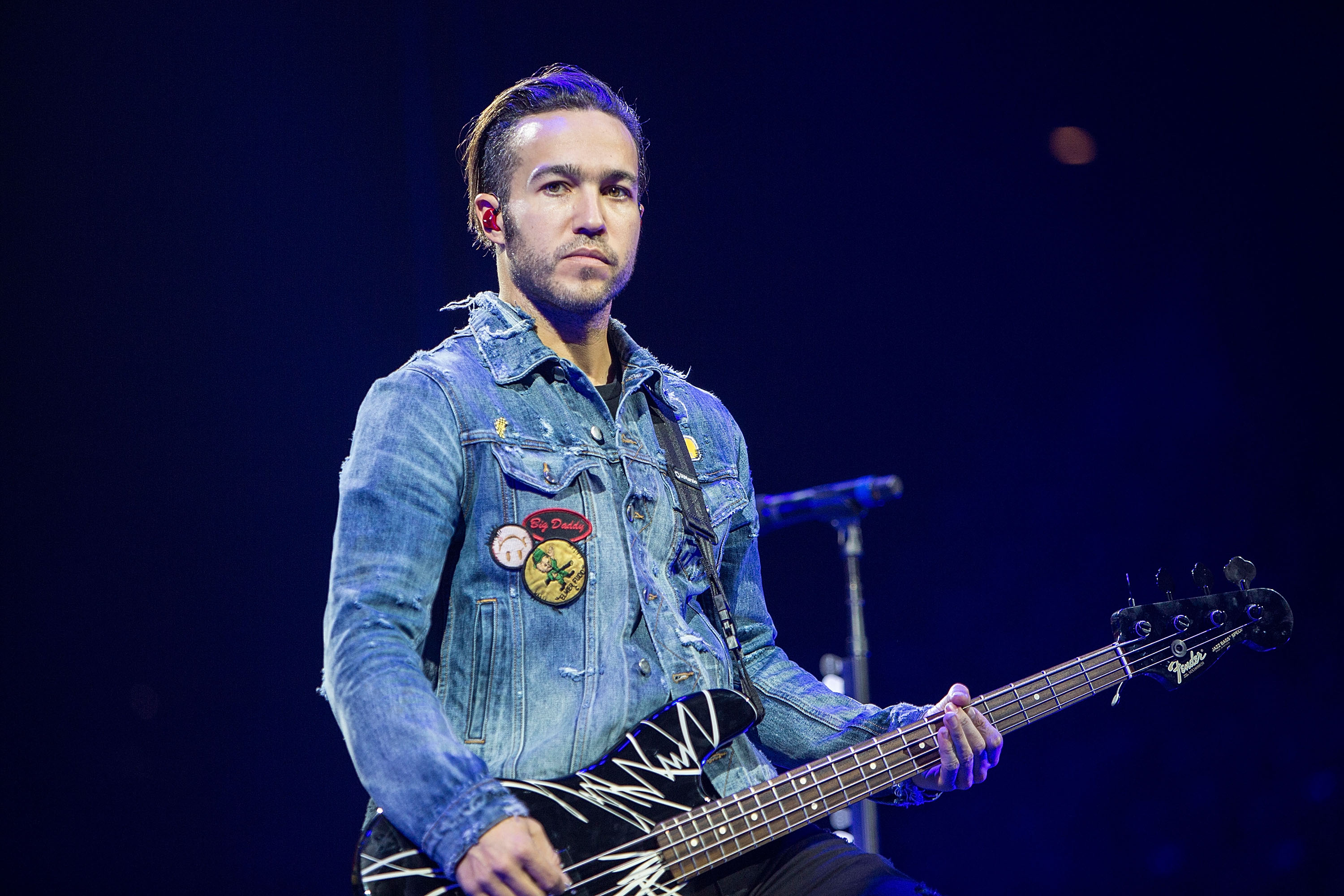 Pete Wentz of Fall Out Boy holding a guitar