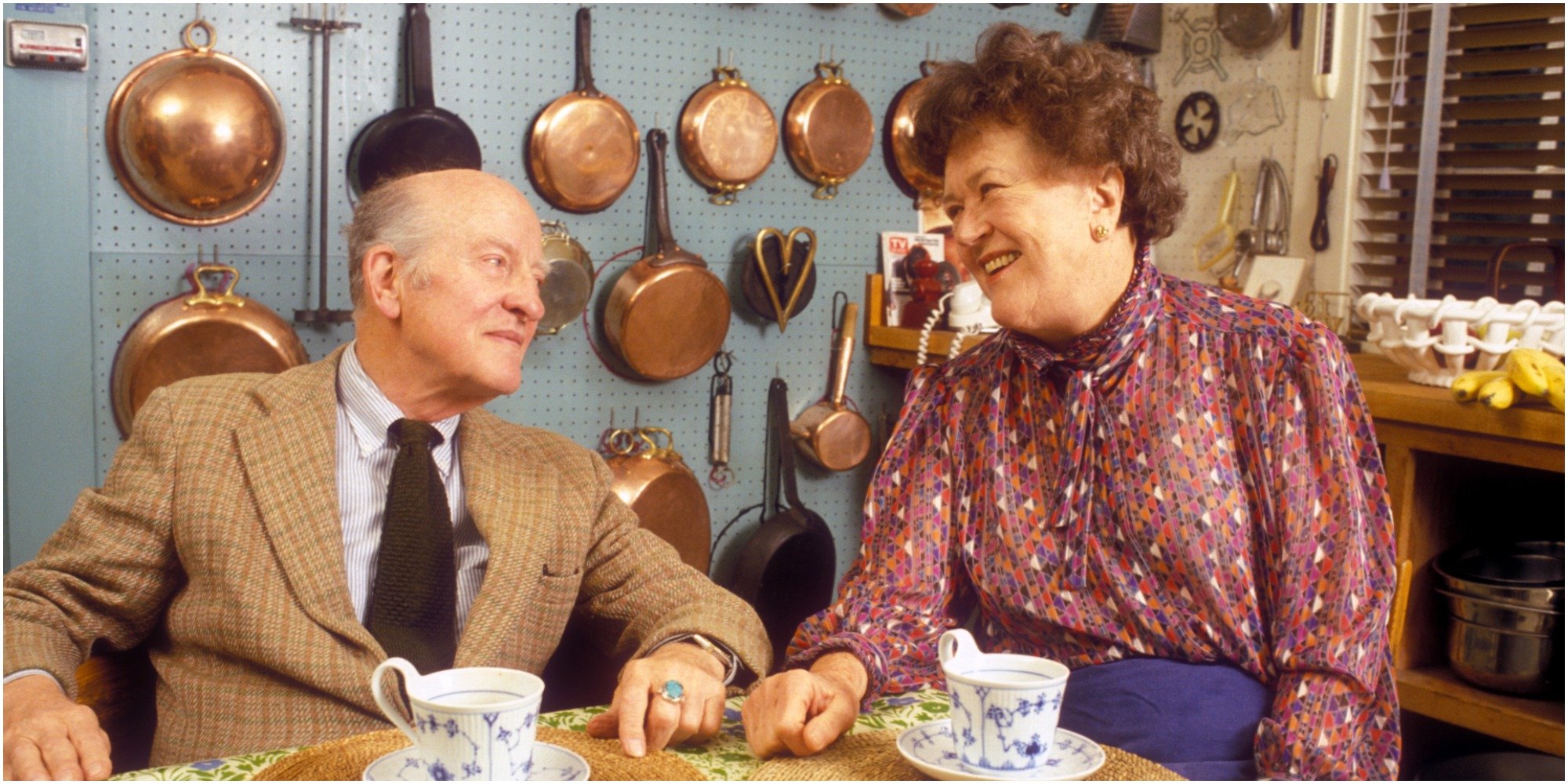 Julia and Paul Child in a photo taken in thier home kitchen.