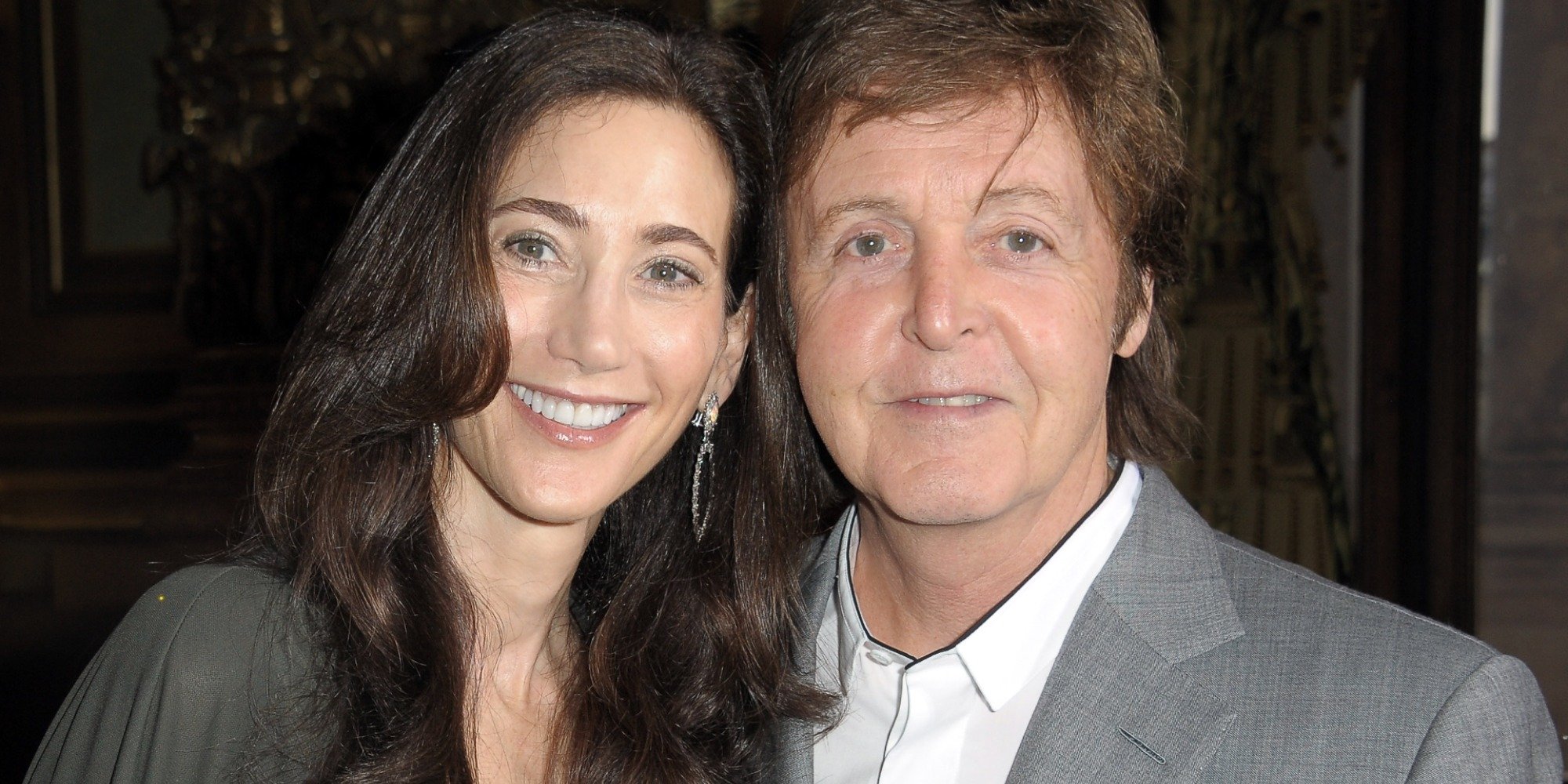 Nancy Shevell and Paul McCartney pose for a press photograph.