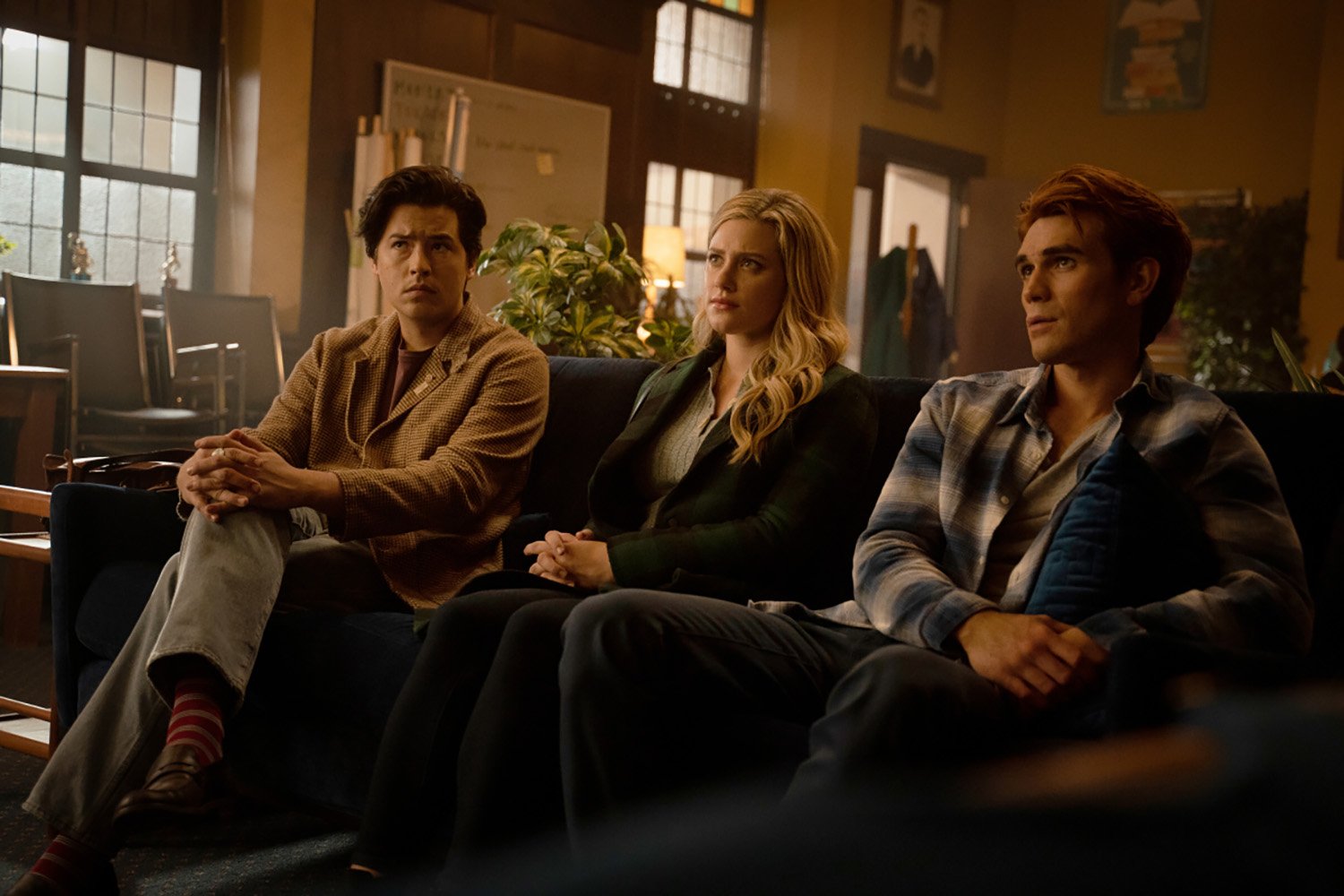 Cole Sprouse as Jughead Jones, Lili Reinhart as Betty Cooper, and KJ Apa as Archie Andrews on Riverdale Season 6, which sees the return of the Trash Bag Killer or TBK