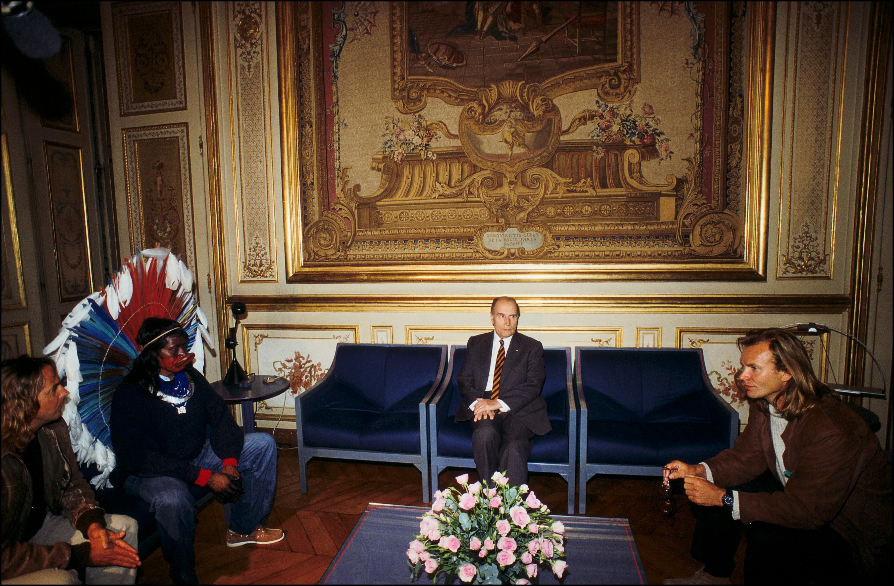 Jean-Pierre Dutilleux, Chief Raoni, Francois Mitterrand, and Sting sitting