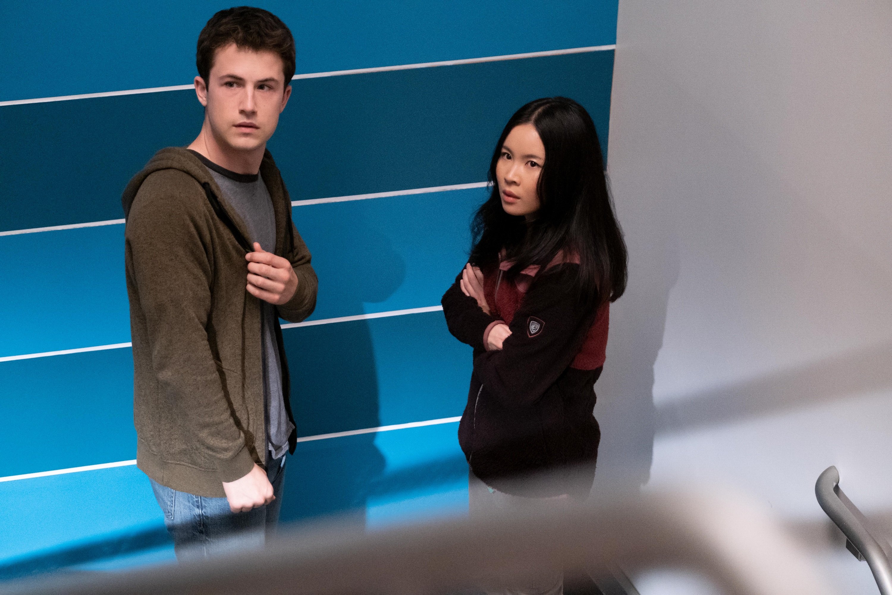 'The Dropout' Tyler Shultz and Erika Cheung portrayed by Dylan Minnette and Camryn Mi-young Kim talking together in a stairwell