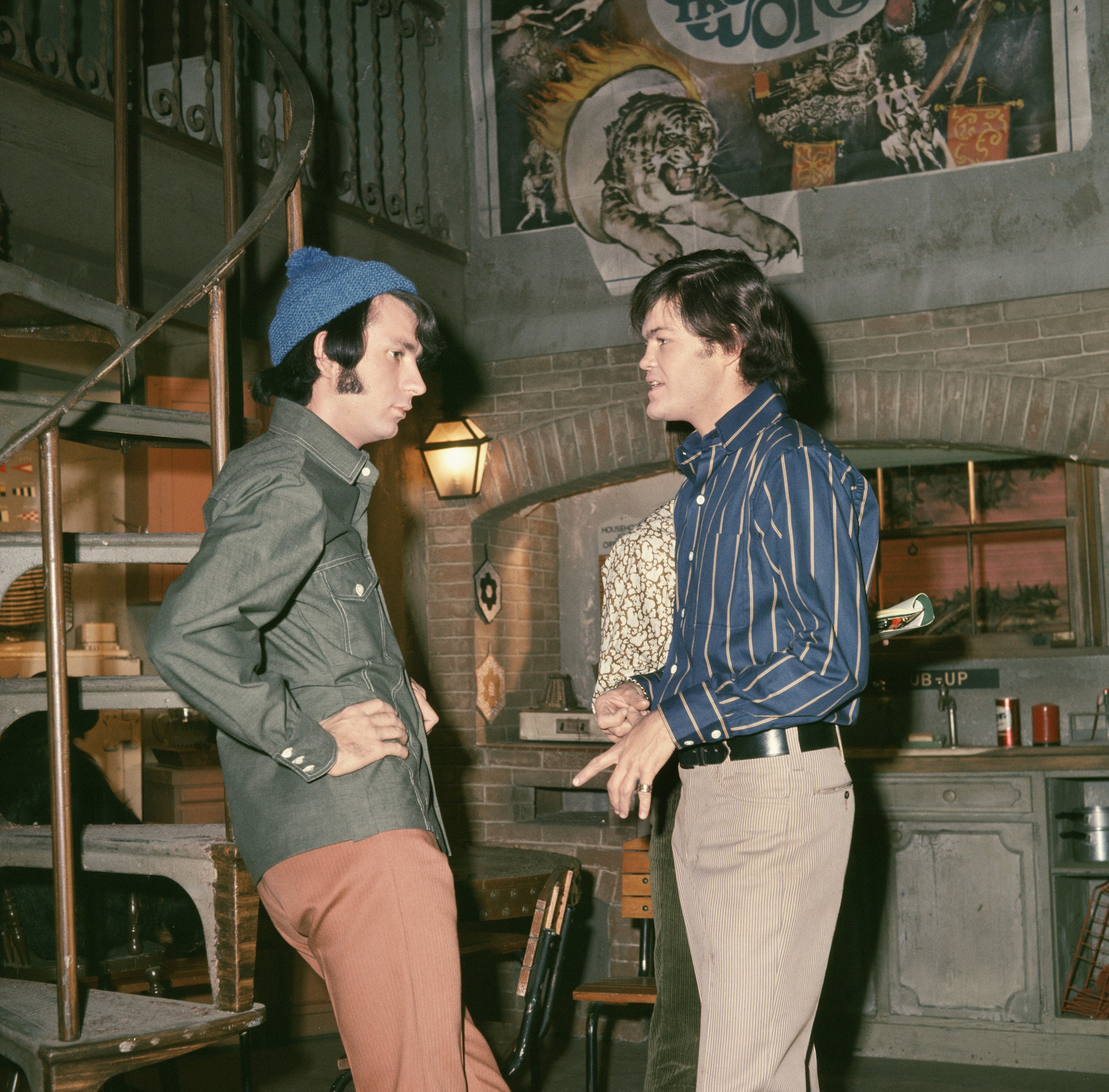 The Monkees' Mike Nesmith and Micky Dolenz standing facing each other and talking