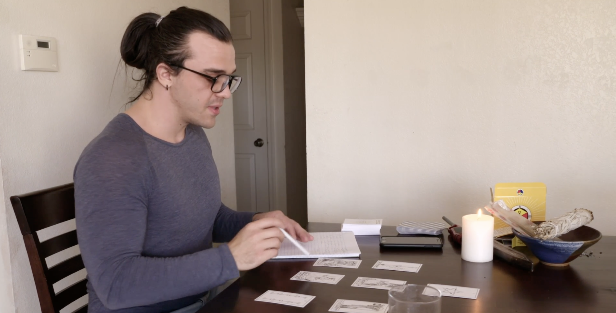 'Before the 90 Days' Season 5 star Caleb sits at a table with tarot cards.