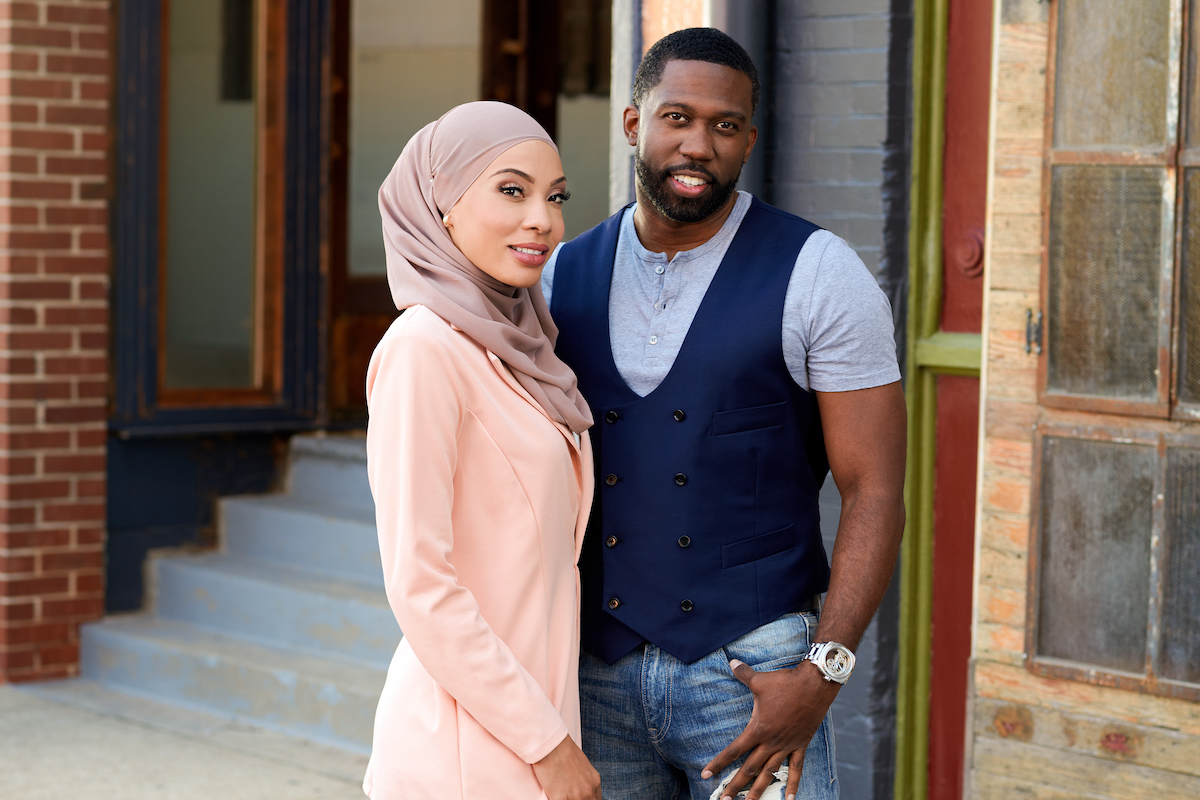 Shaeeda from '90 Day Fiance', dressed in pink and wearing a headscarf, and Bilal, wearing a vest and short-sleeved shirt standing next to each other