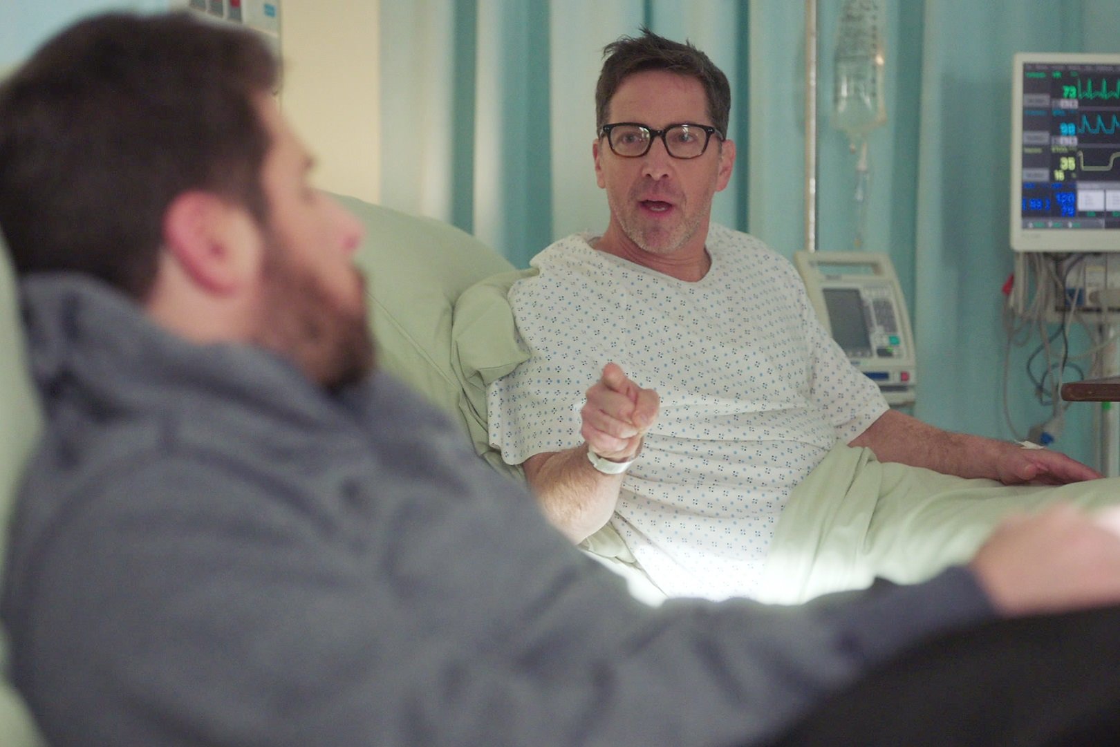 Dan Bucatinsky plays Harrison pointing at Gary from a hospital bed in 'A Million Little Things'