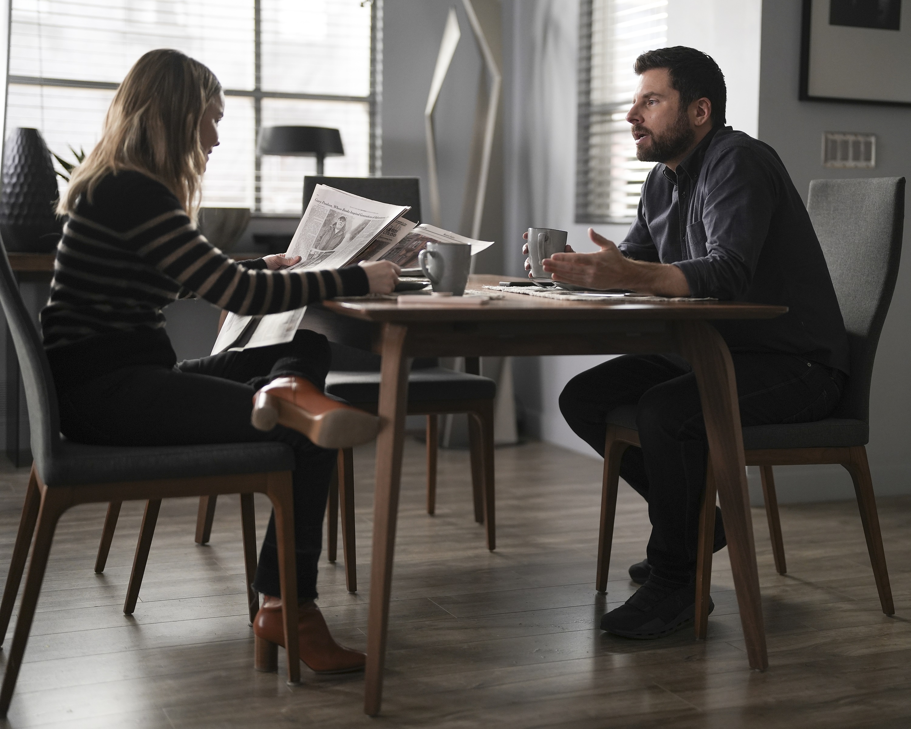 'A Million Little Things' Season 4 Allison Miller and James Roday Rodriguez sit at a table together as Maggie Bloom and Gary Mendez