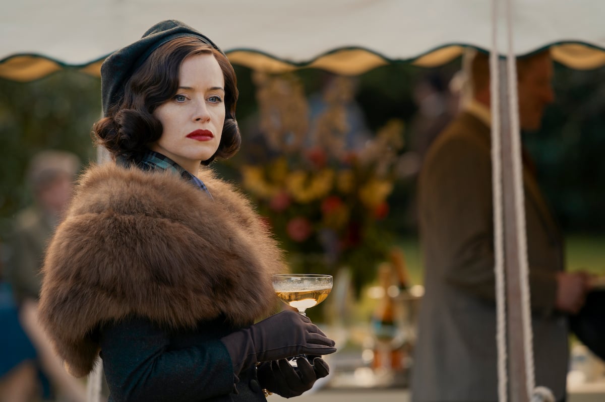 Claire Foy as Margaret Campbell, holding a champagne coupe, in 'A Very British Scandal'