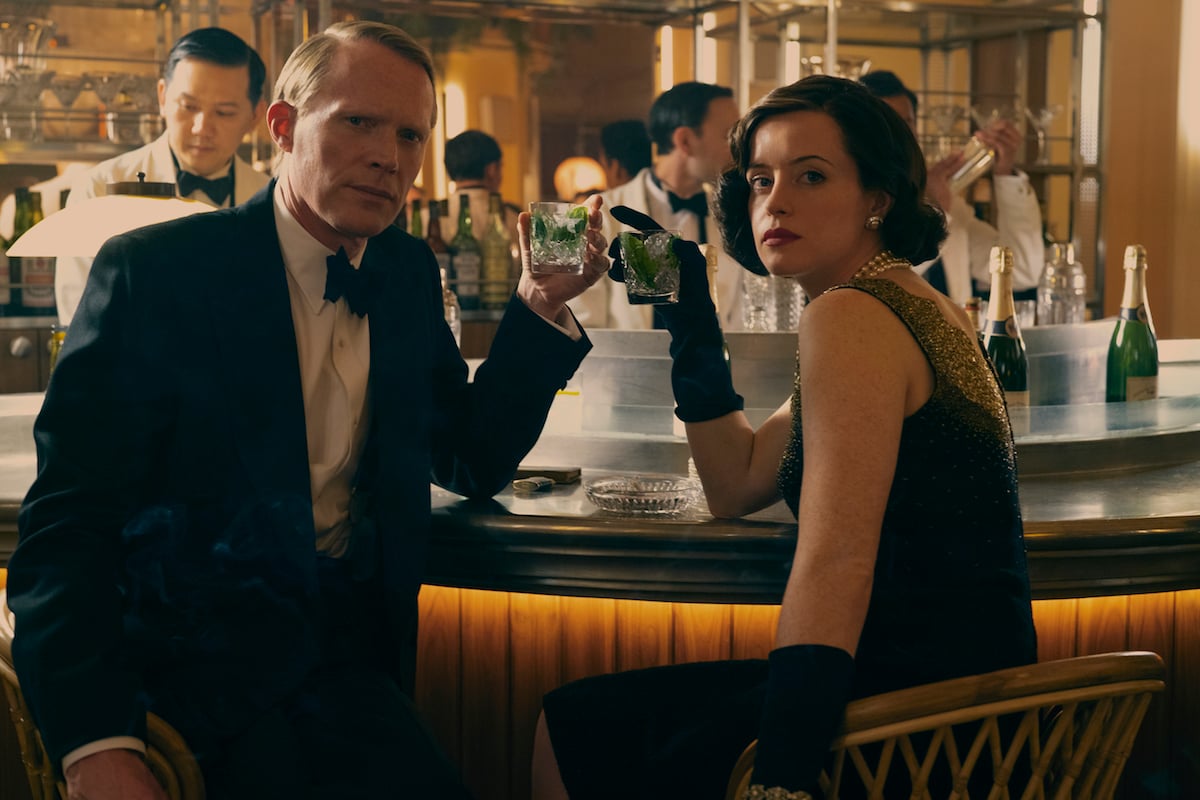 Paul Bettany and Claire Foy sitting at a bar in 'A Very British Scandal'