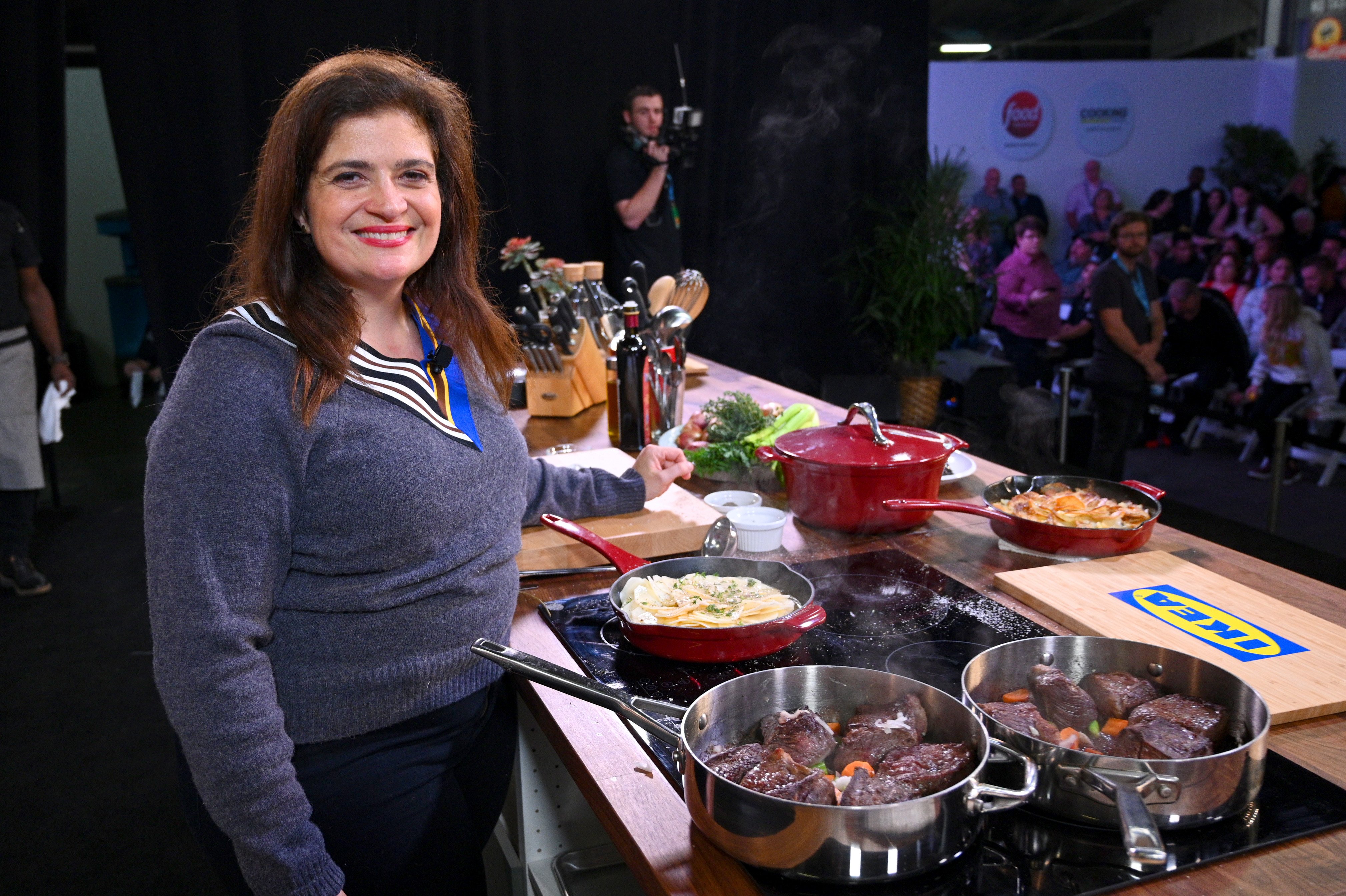 Food Network personality Alex Guarnaschelli wears a long-sleeved gray sweater in this photograph.