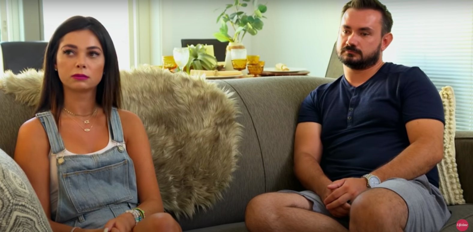 Alyssa and Chris sitting on a couch during an episode of 'Married at First Sight' Season 14