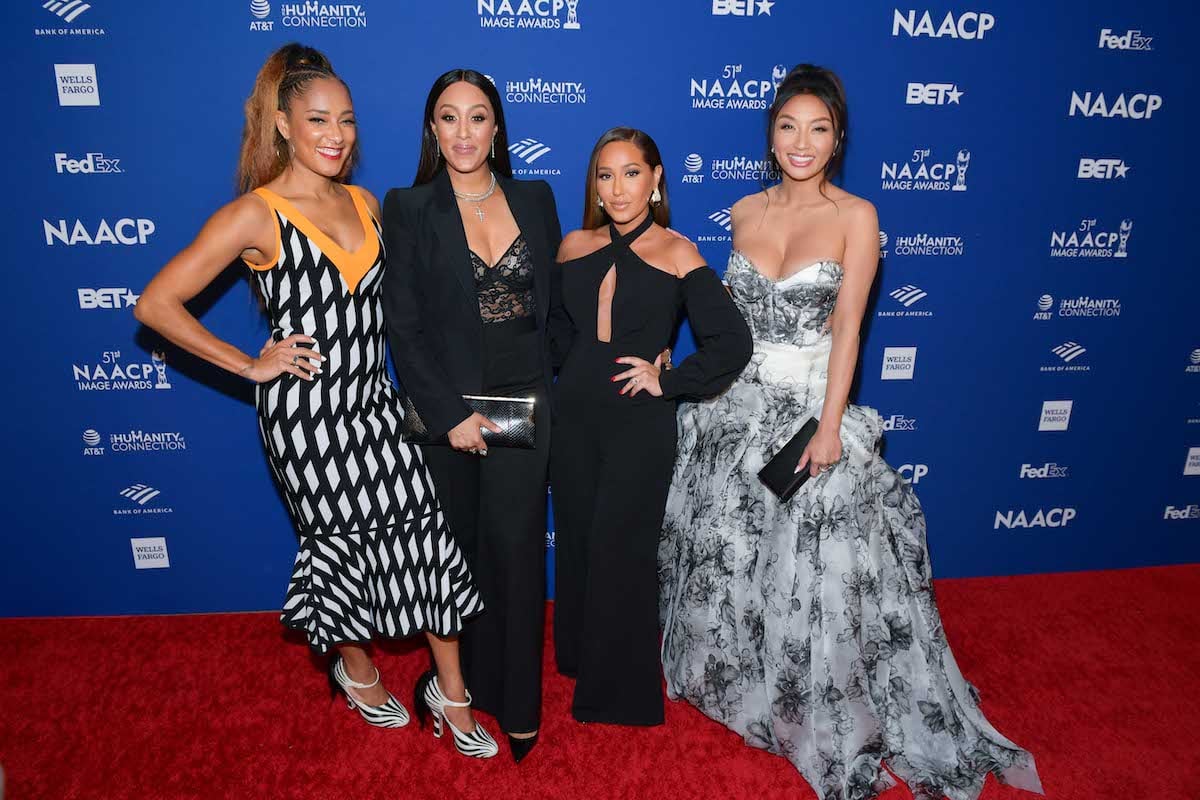 Amanda Seales poses for a photo with Adrienne Bailon, Tamera Mowry-Housley, and Jeannie Mai when they were hosting 'The Real' talk show