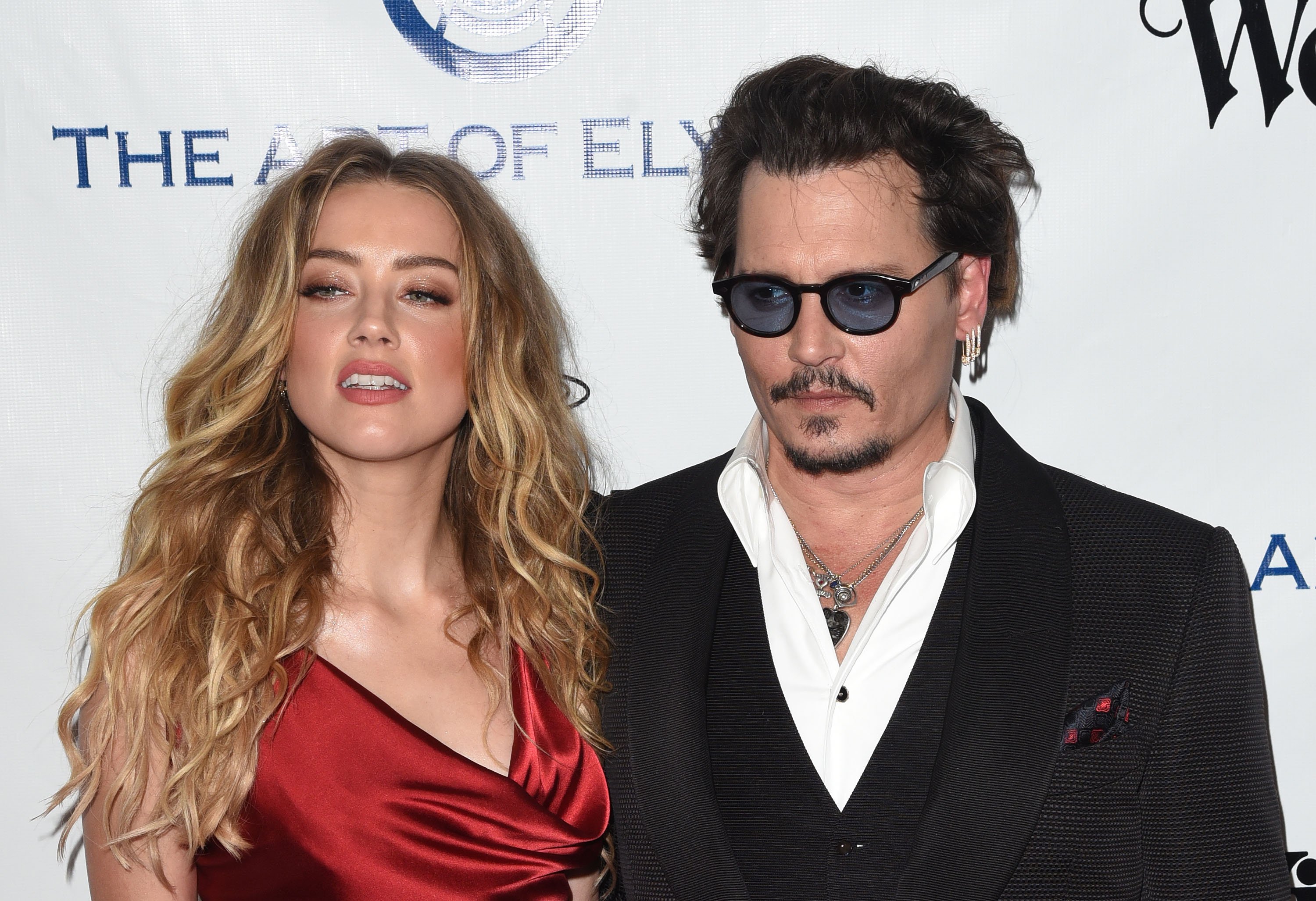 Amber Heard and Johnny Depp, who celebrity chef Leon Rothera cooked for, smiling on the carpet at The Art of Elysium 2016 HEAVEN Gala