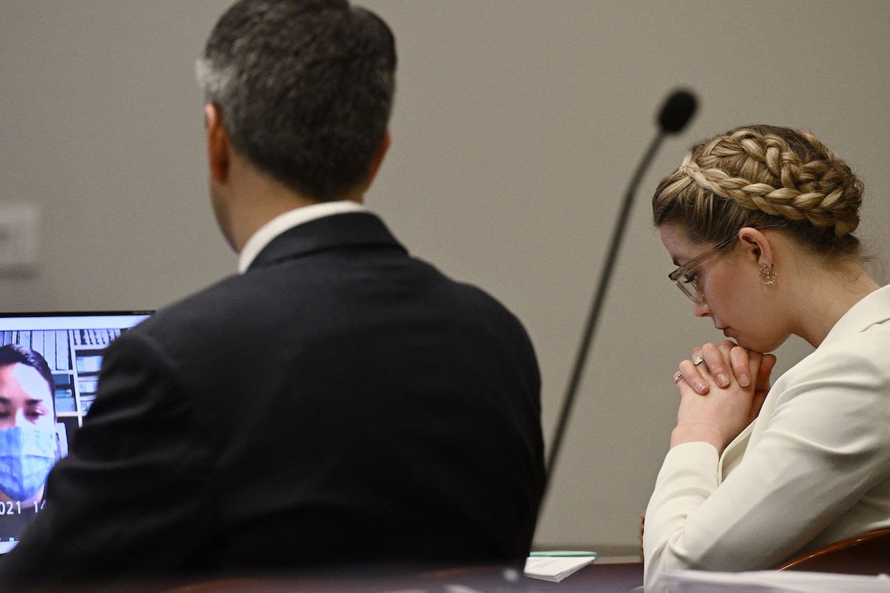 Amber Heard listens in the courtroom
