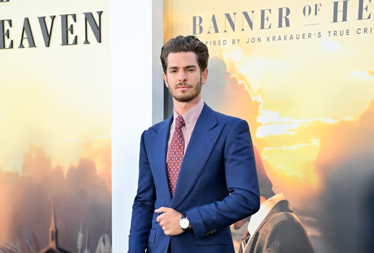 Under the Banner of Heaven star Andrew Garfield at the series premiere on April 20, 2022, in Hollywood, California, wearing a blue suit