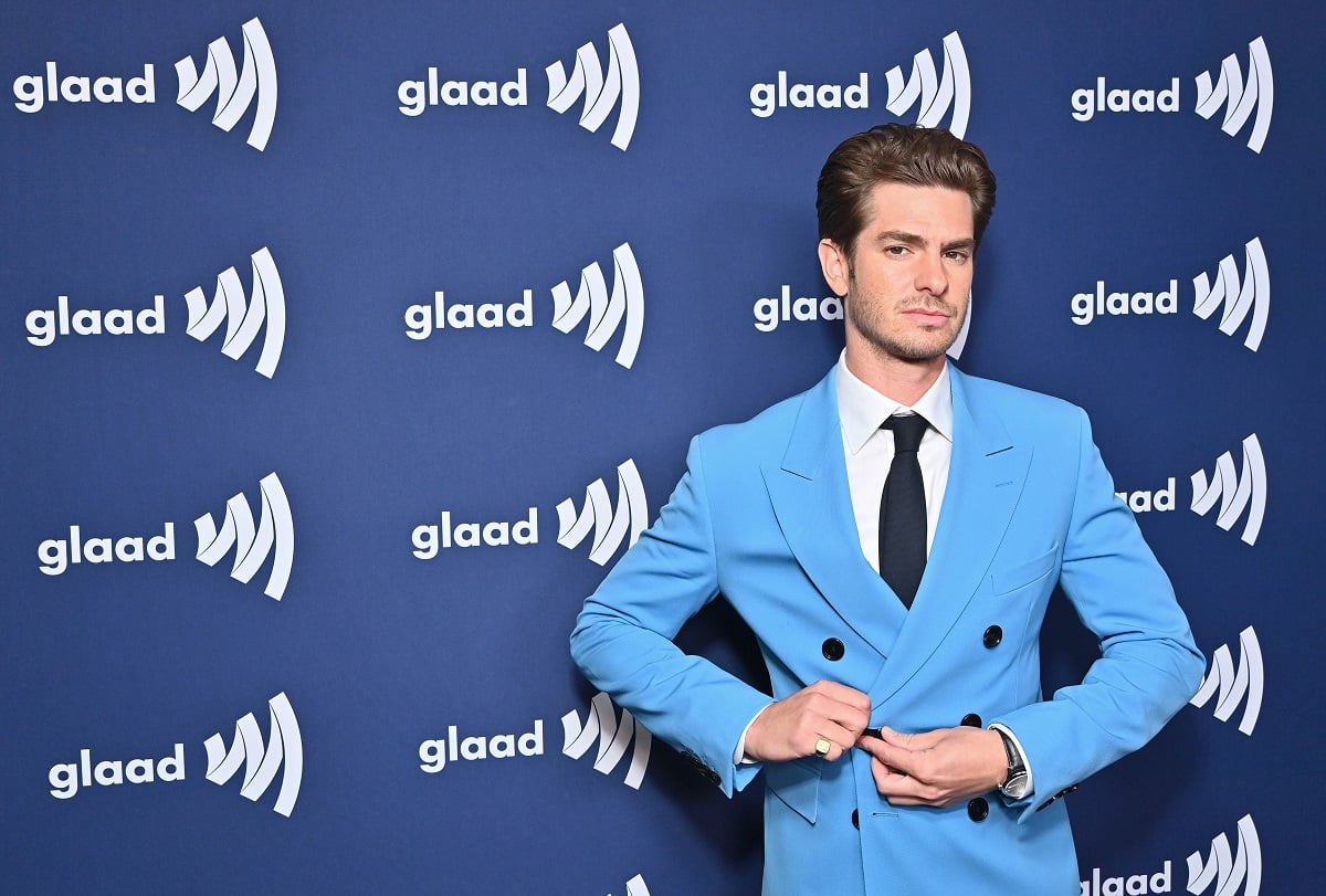 Andrew Garfield posing while wearing a blue suit.