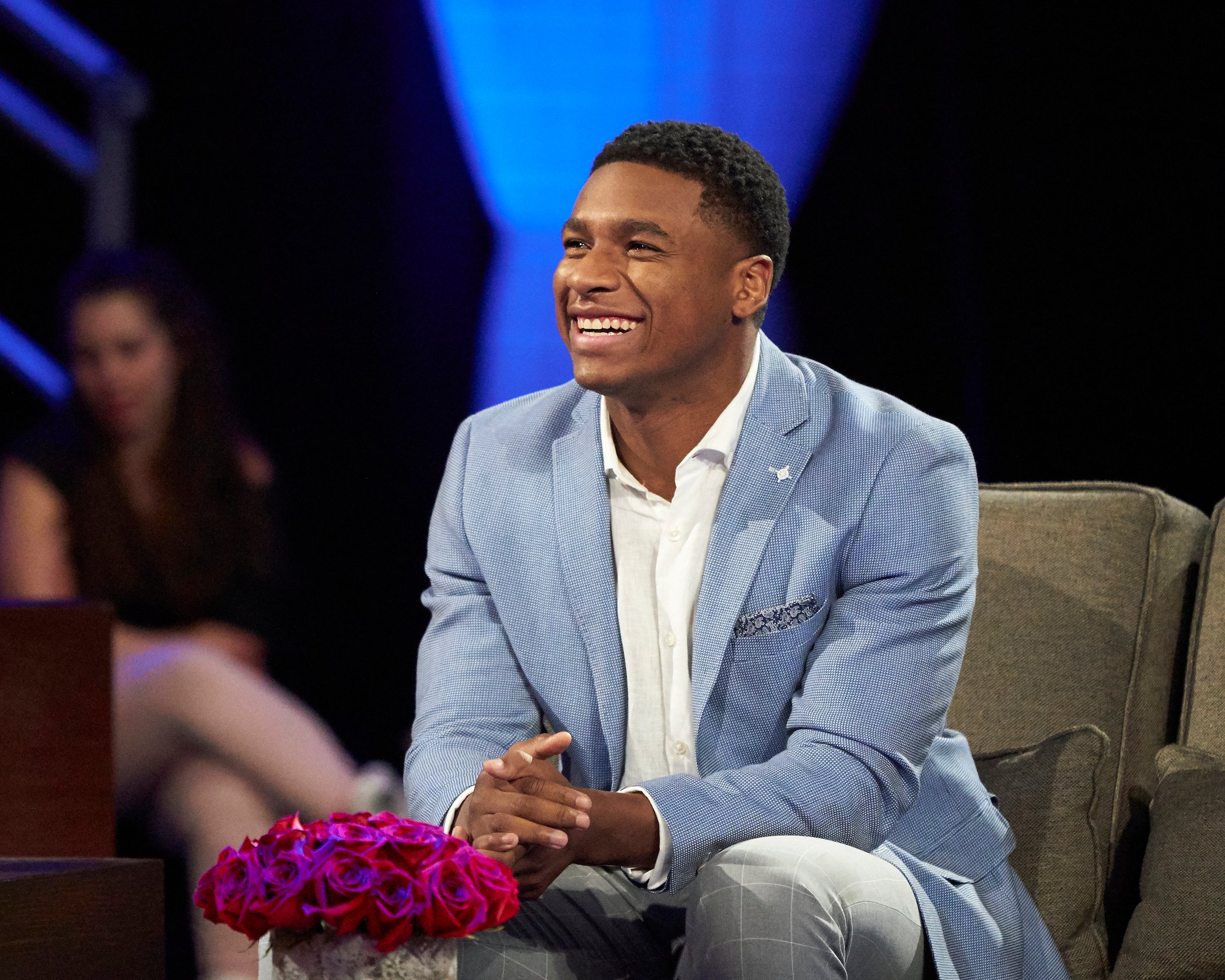 Andrew Spencer, a possible 'Bachelor in Paradise' Season 8 cast member, smiling and laughing on stage during the 'Men Tell All' for 'The Bachelorette'