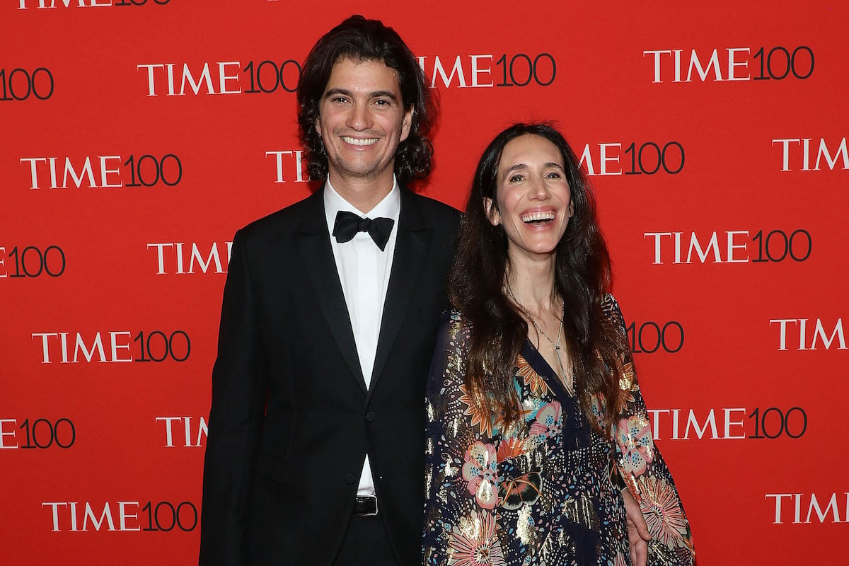 Adam and Rebekah Neumann smile while standing on the red carpet of the 2018 Time 100 Gala