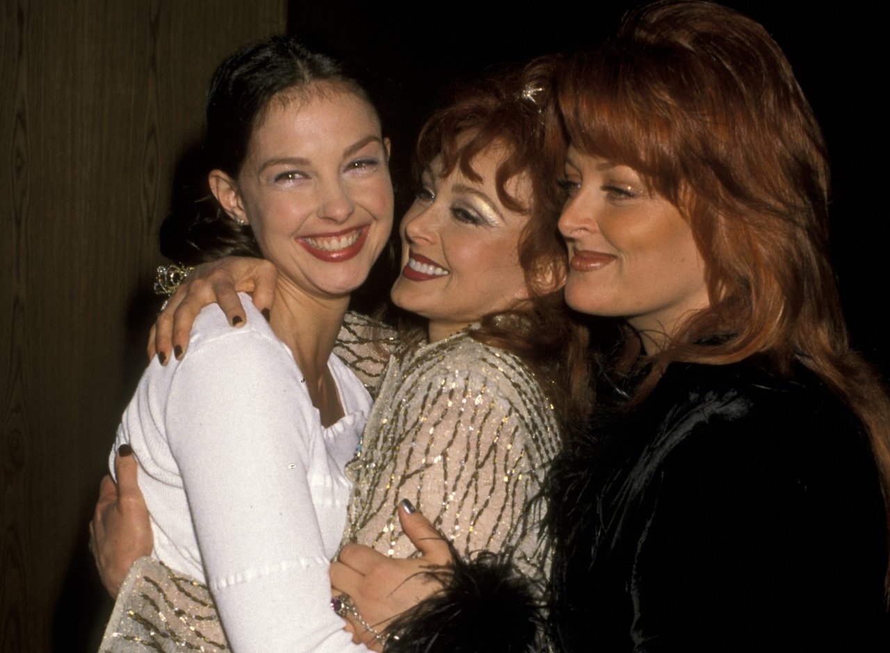 (L-R) Ashley Judd, Naomi Judd and Wynonna Judd embrace for a picture