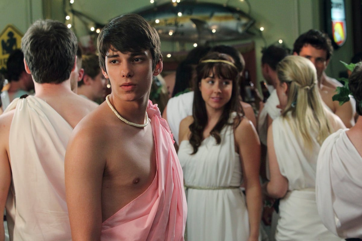 Devon Bostick as Leo Strange (Front) and Erin Karpluk as Erica Strange (background)