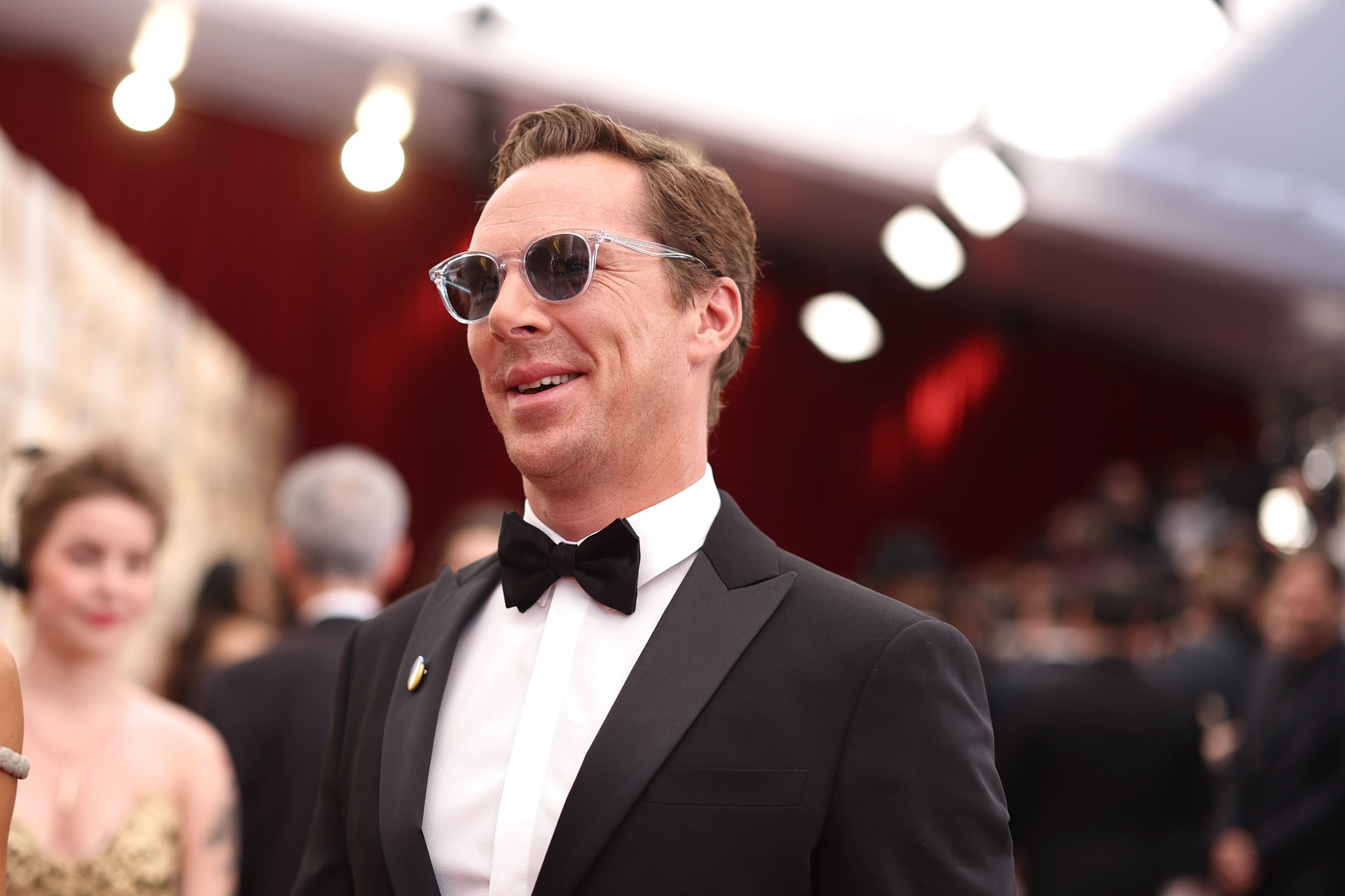 'Doctor Strange 2' star Benedict Cumberbatch wears a black suit over a white button-up shirt and black bow tie, and the actor wears sunglasses.