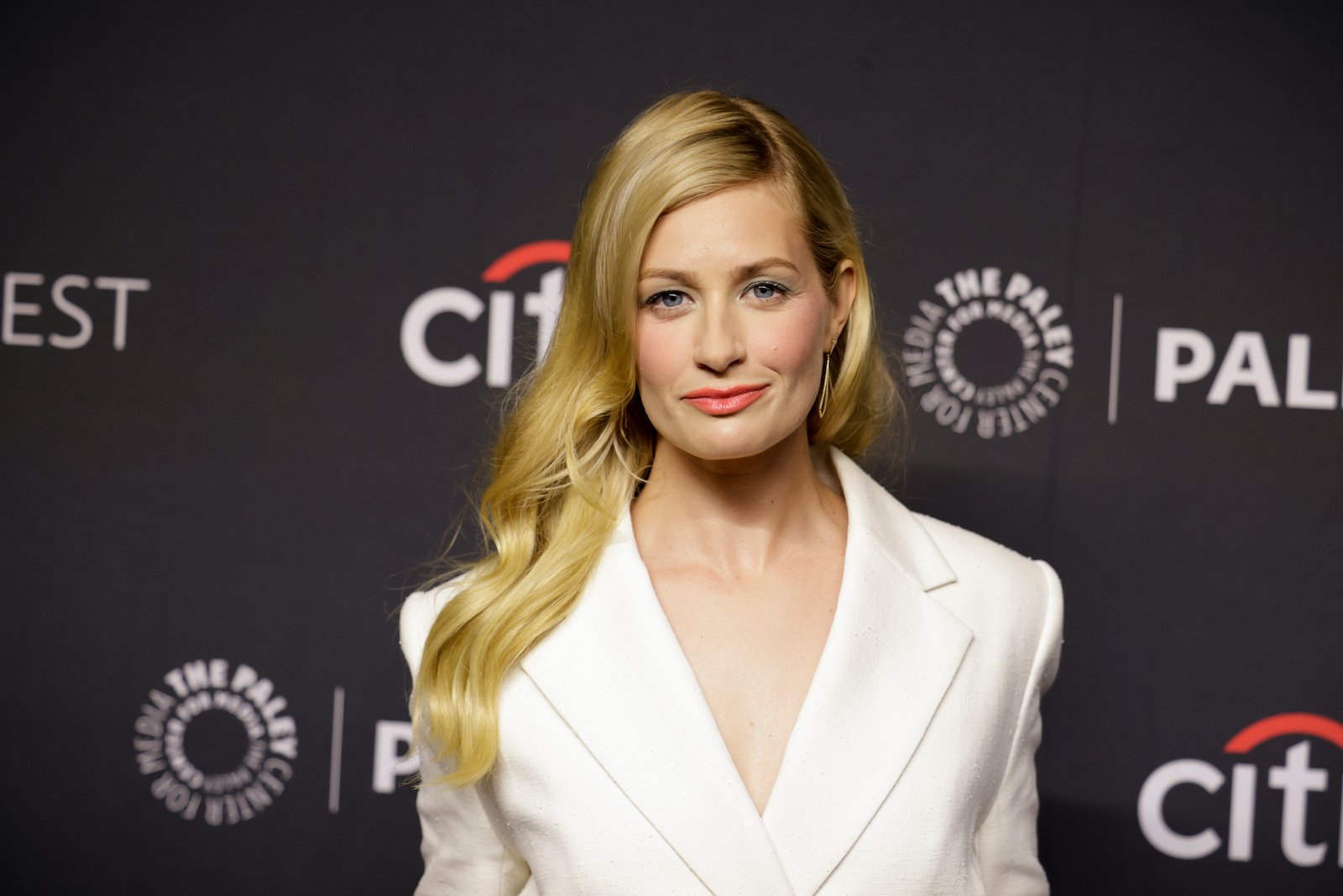 Beth Behrs from 'The Neighborhood' poses for a photo at an event. 