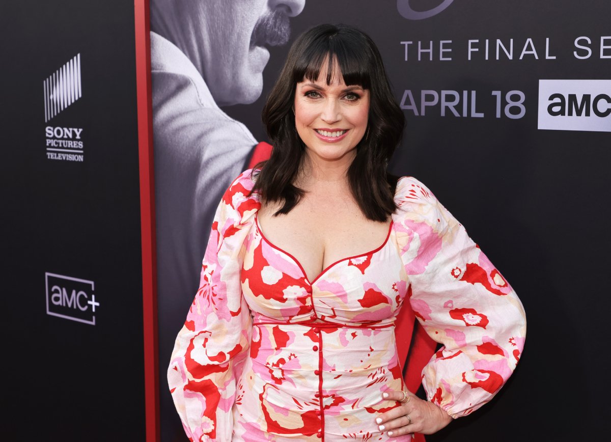 Julie Ann Emery attends the premiere of the sixth and final season of AMC's Better Call Saul at Hollywood Legion Theater. Emery wears a pink patterned dress. 
