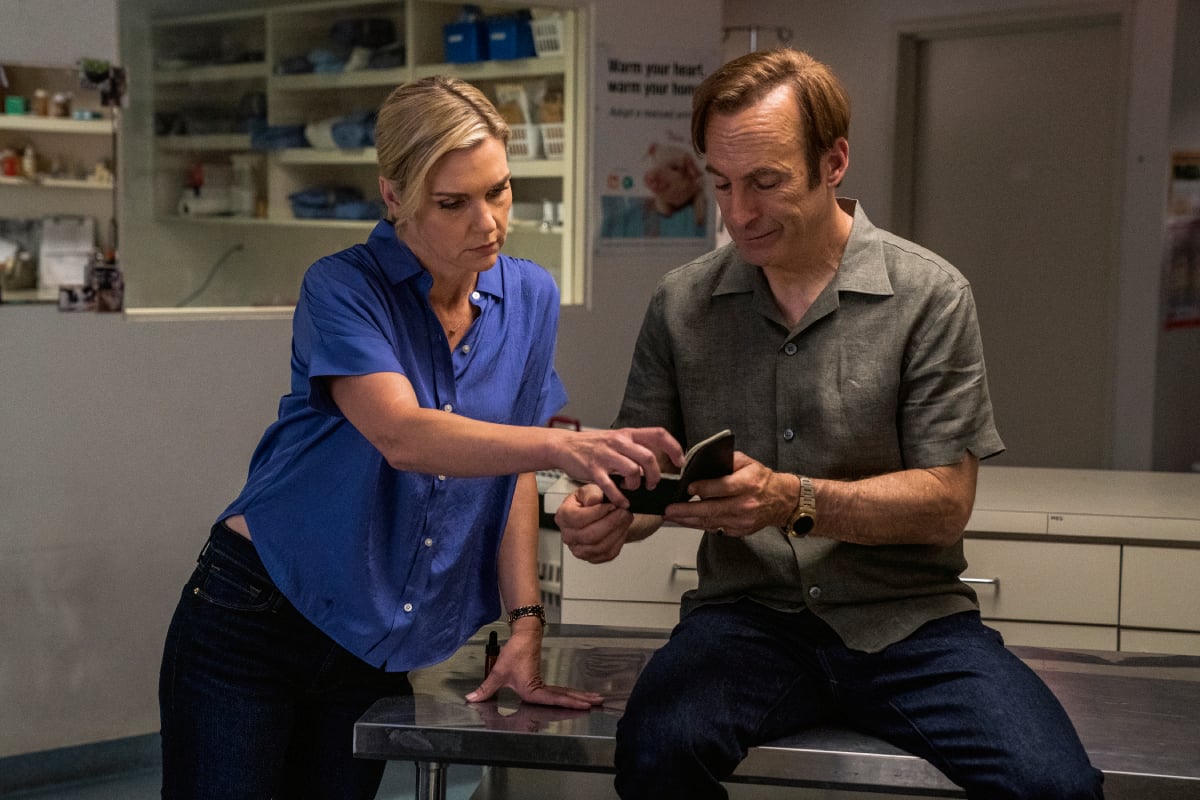 Bob Odenkirk as Jimmy McGill, Rhea Seehorn as Kim Wexler in Better Call Saul Season 6. Kim and Jimmy look at a notebook that Jimmy is holding. 