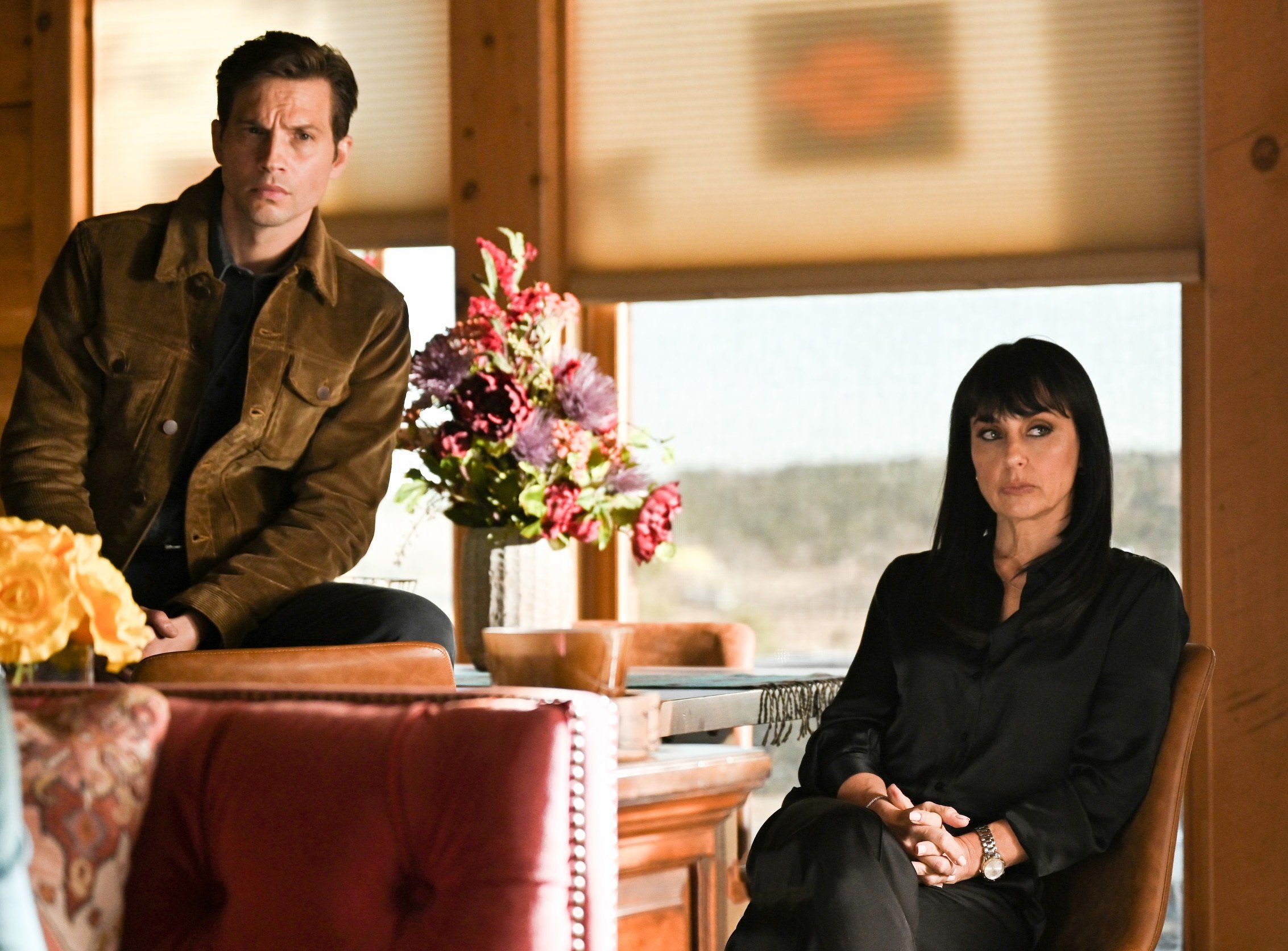 'Big Sky' Season 2 Episode 15 Logan Marshall-Green and Constance Zimmer sit looking concerned as Travis and Alicia