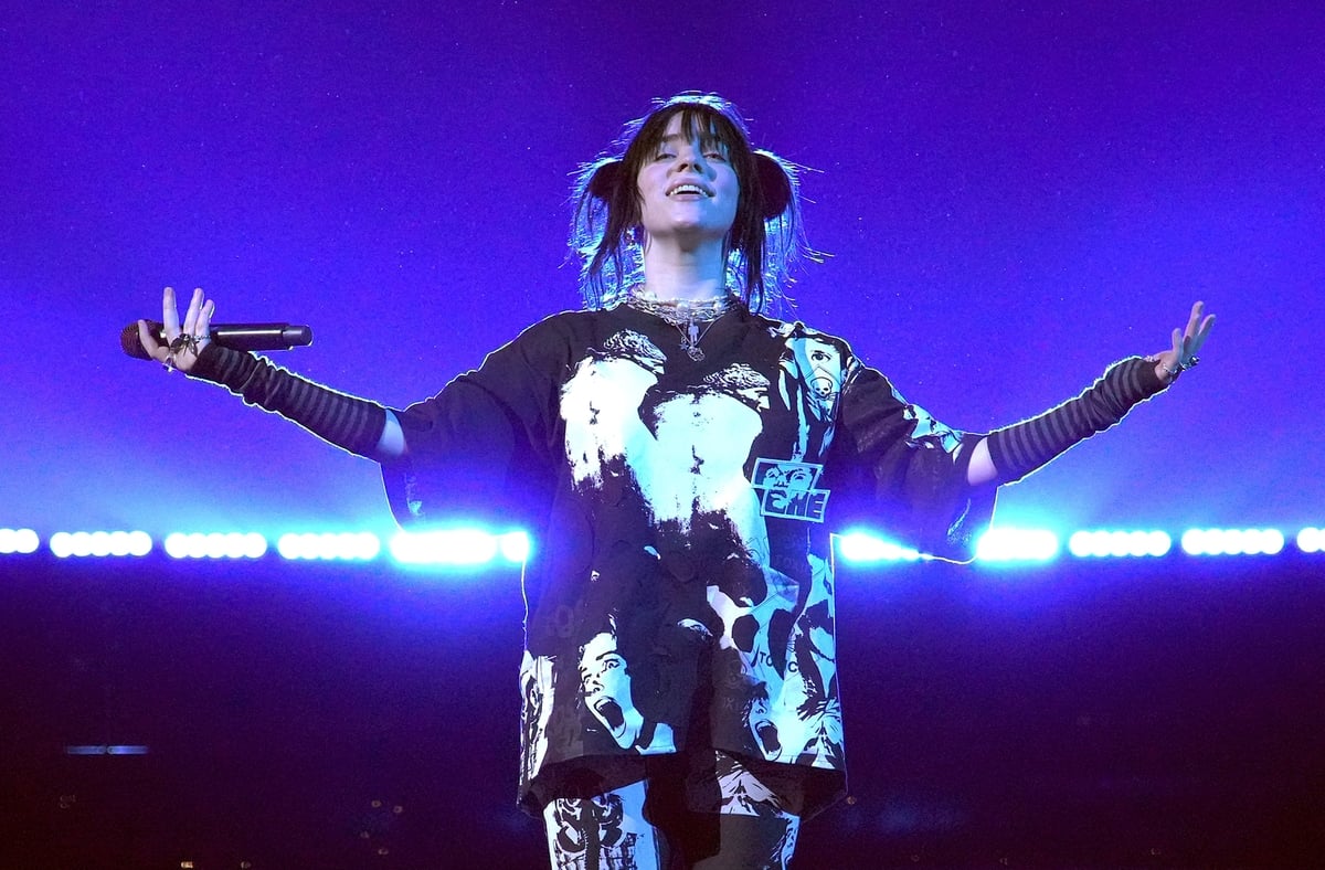 Dressed in black and white Billie Eilish performs onstage during the Happier Than Ever tour in Inglewood, CA. She is headlining Coachella this weekend. 