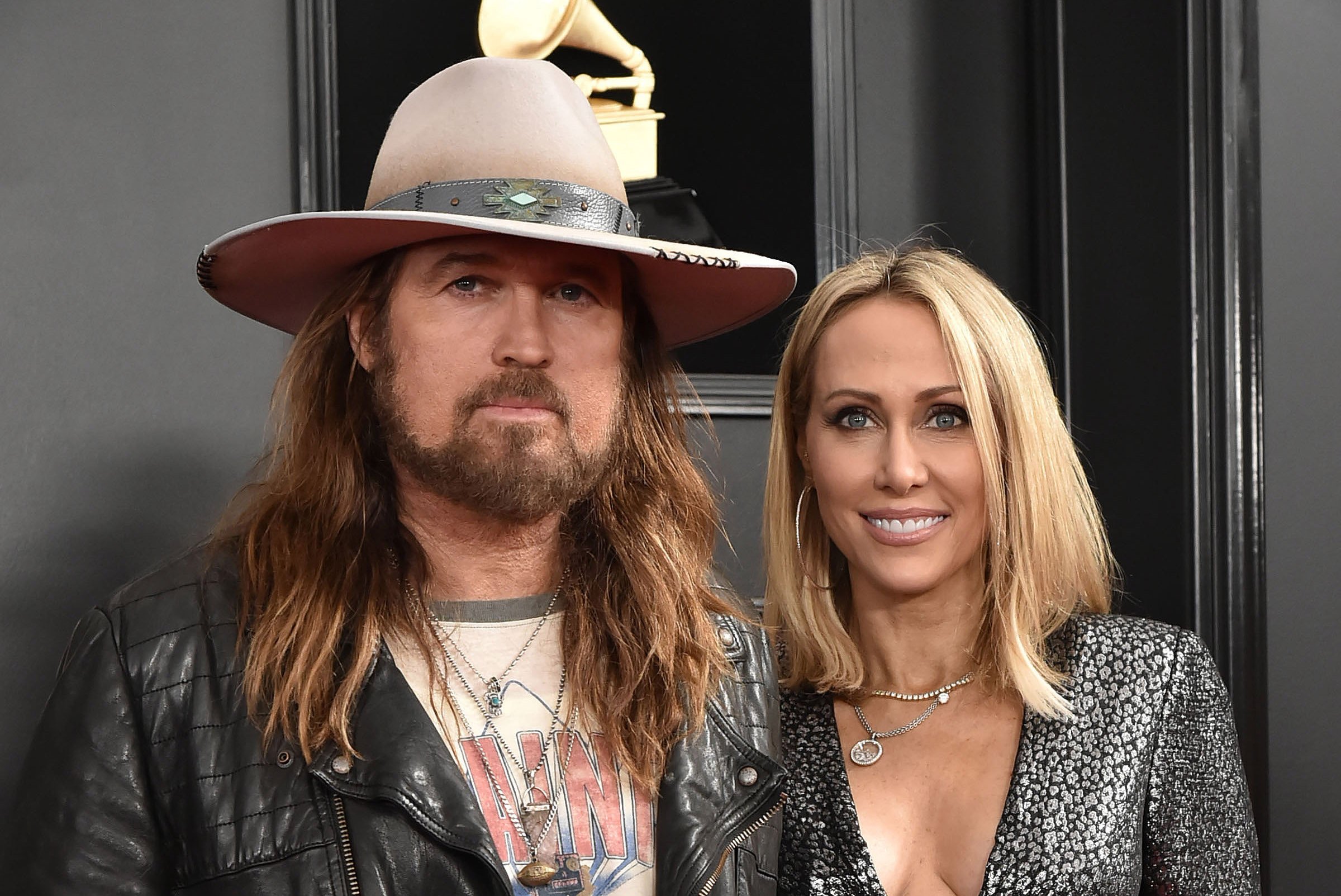 Billy Ray Cyrus and Tish Cyrus posing at the Grammy Awards